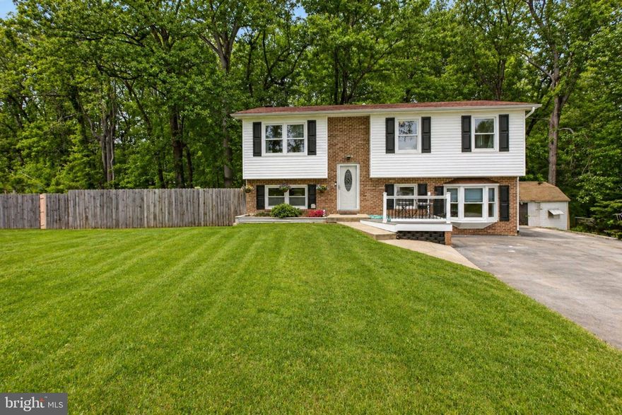 Situated on approximately one acre, this split-level home offers generous indoor and outdoor living surrounded by mature trees and natural scenery. The landscaped front yard and extended driveway create a welcoming first impression. The home's layout supports both everyday living and weekend retreats.
The main level includes a comfortable living area with a fireplace, along with a functional kitchen featuring ample cabinetry and workspace. Large windows throughout bring in natural light and provide views of the surrounding greenery. The finished basement expands the living footprint and can serve as a recreation room, guest space, home office, or additional gathering area. Multiple storage options and flexible rooms add to the home's versatility.
The expansive lot allows room for gardening, outdoor activities, or future enhancements.
Located near Golden Beach Road and easily accessible to Dudley Road and Route 261, the property allows travel toward Chesapeake Beach, North Beach, and surrounding Southern Maryland communities. Nearby Indian Creek and surrounding natural areas enhance the appeal for outdoor enthusiasts, while local parks, waterfront areas, and marinas are just a short drive away.  5 minutes to a local winery! 
This setting also presents potential for a weekend getaway, primary residence, or short-term rental opportunity.
Buyers looking for privacy, outdoor living, and flexible space will appreciate the possibilities this home offers. Schedule your showing today and explore the potential of this scenic property.