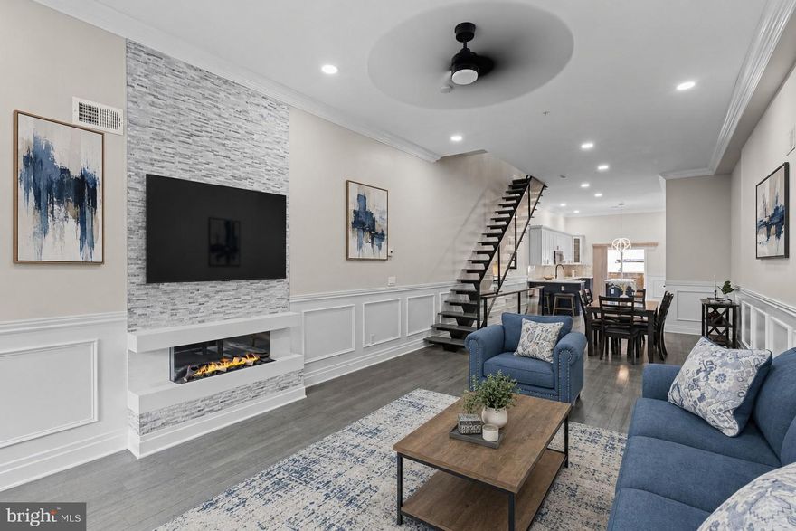 Welcome to The Estates at Queen Village, a collection of newly constructed luxury townhomes in one of Philadelphia’s most sought-after neighborhoods, offering sophisticated city living with a 10-year tax abatement. This stunning residence seamlessly blends modern elegance with timeless design, featuring an expansive open-concept main level perfect for entertaining, complete with a gorgeous chef’s kitchen showcasing quartz countertops, striking navy and white cabinetry, professional-grade Viking appliances including a built-in refrigerator and gas range, and an oversized island ideal for dining and gathering. Natural light pours throughout the home, highlighting the spacious layout and high-end finishes at every turn. The second floor offers two generously sized ensuite bedrooms, while the entire third level is dedicated to a luxurious primary retreat featuring a custom walk-in closet, wet bar, spa-inspired bathroom with a soaking tub, glass-enclosed shower, and dual vanities, plus a conveniently located laundry room. A full-length rooftop terrace with panoramic city views and upgraded lighting creates the perfect setting for entertaining or relaxing under the stars. The finished lower level provides flexible living space ideal for a home office, gym, media room, or guest suite, along with an additional laundry area for added convenience. Thoughtfully designed, this exceptional Queen Village home offers the ultimate luxury urban lifestyle surrounded by charming tree-lined streets, acclaimed dining, boutiques, and cultural attractions. Taxes and Association fees are not $1 and are TBD. Taxes and square footage are the responsibility of the buyer to have verified independently.