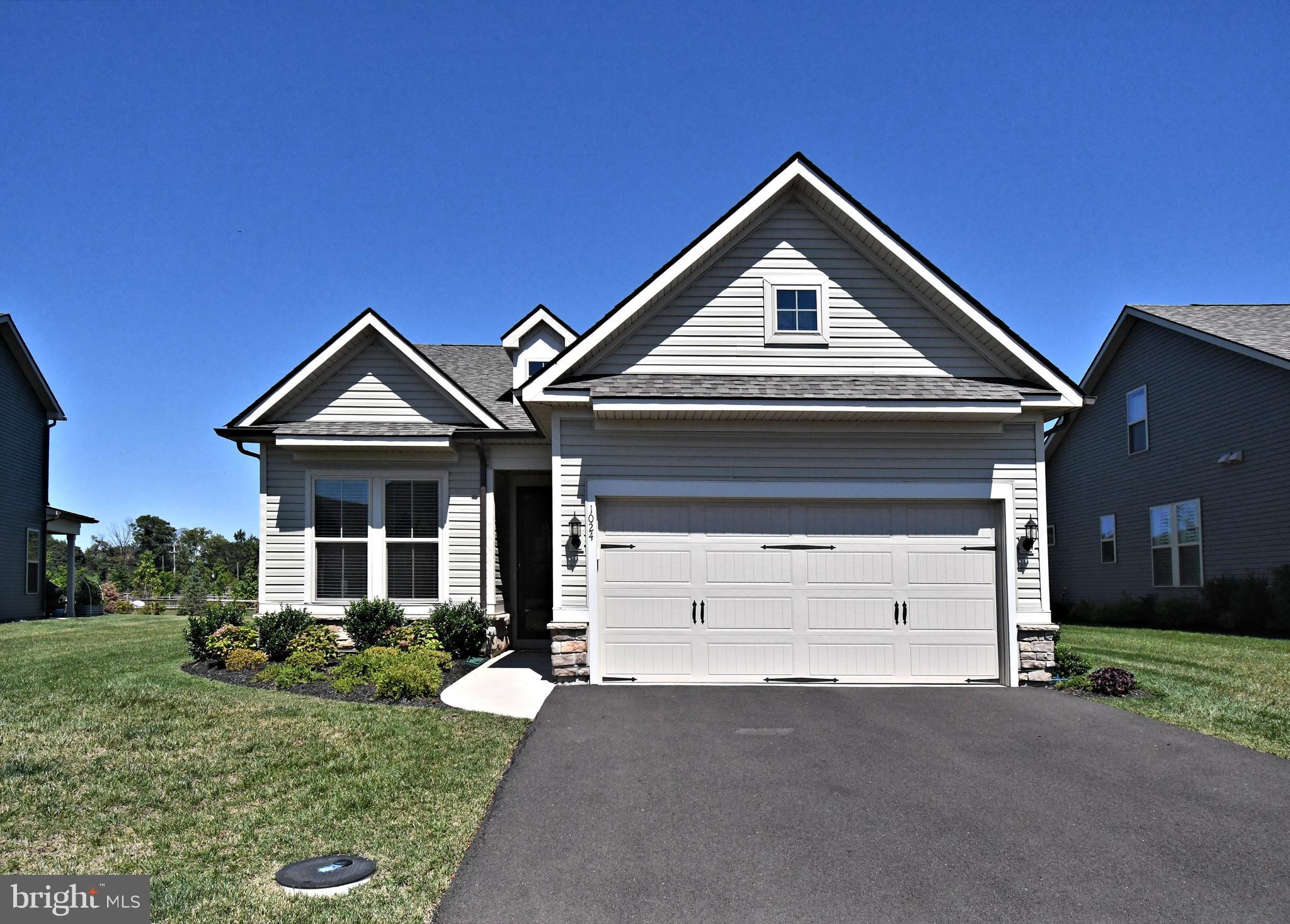 This impeccacable ranch-style residence, located in a premier 55+ community, is just two years young and thoughtfully designed for comfort and style. The open floor plan features hardwood floors in the kitchen, breakfast area, hallway, and family room. The modern kitchen is enhanced by a stunning backsplash, Quartz countertops, and gas cooking , an island with a sink and a sophisticated neutral design.
The luxurious primary suite features a double-sink vanity with granite countertops, offering both elegance and functionality. Large primary bedroom with abundance of closet space.
A two-car garage with a 4-foot extension and electric door openers provide extra storage and convenience. Situated on a premium lot backing to open space, the home offers a peaceful patio in the backyard for relaxing or entertaining.
Enjoy resort-style living with a community clubhouse featuring a pool, hot tub, game room, exercise room, large kitchen, pickleball, and tennis courts—perfect for an active and social lifestyle.