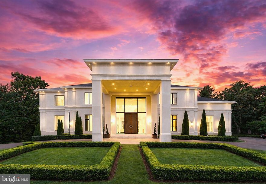 Introducing 8880 Bradley Blvd, a striking contemporary estate set on a fully gated two-acre parcel in one of Bethesda’s most prestigious enclaves. Designed for those who value architectural distinction, privacy, and resort-caliber living, this extraordinary residence offers approximately 13,750 square feet across three levels, with 7 bedrooms, 7 full baths, 2 half baths, and a custom hydraulic elevator serving every floor.

From the moment of arrival, the estate makes a commanding impression. An app-controlled arched iron gate opens to a long, scenic approach, culminating in a circular motor court, manicured grounds, and a custom Italian bronze entry door. Inside, the dramatic foyer rises to 24-foot ceilings and is crowned by a sculptural custom light installation by Cameron Design of London, setting the tone for the home’s bold modern aesthetic and refined craftsmanship.

Created for both grand entertaining and seamless daily living, the residence showcases expansive interiors, clean architectural lines, sophisticated finishes, and state-of-the-art smart home integration. The main kitchen is appointed with commercial-grade appliances and exceptional workspace, while a separate scullery kitchen with its own entrance provides ideal support for catered events, staff, or effortless everyday functionality.

The home’s lower level delivers a true private wellness and entertainment retreat. Thoughtfully designed for leisure at the highest level, it features a Turkish bath with separate warm room and heated marble surfaces, a fully equipped fitness studio, state-of-the-art theater, wine and cigar lounge, and an additional kitchenette with full-size refrigerator, dishwasher, and microwave.

Upstairs, the private quarters continue the home’s sense of elevated comfort and calm. The owner’s suite is a sanctuary unto itself, complete with a spa-inspired bath with heated floors, an expansive two-room dressing area, and a serene sitting room with morning bar. Each secondary bedroom is generously scaled and beautifully appointed.

The exterior amenities rival those of a luxury resort. Framed by mature trees for exceptional privacy, the outdoor living environment includes a saltwater pool with infinity edge, mosaic-tiled spa, four gas fire pits, and a cabana pavilion with outdoor kitchen, fireplace, and generous entertaining areas. Whether envisioned as a private family compound, ambassadorial residence, or executive retreat, the estate offers a rare combination of grandeur and seclusion.

A four-car attached garage with Porsche charging station, basketball hoop, and air conditioning adds further convenience. Throughout the home, remote-controlled window treatments, expansive windows, whole-house soundproofing and insulation, central vacuum, app-controlled surround sound, advanced security, five commercial-grade HVAC systems, two 75-gallon hot water tanks, and generator backup underscore the property’s exceptional infrastructure and readiness.

Only minutes from the finest golf, acclaimed schools, upscale shopping, fine dining, and the heart of Washington, D.C., 8880 Bradley Blvd offers a lifestyle that is at once prestigious, private, and profoundly peaceful. Whether serving as a family legacy property, an ambassadorial residence, or a refined executive escape, this remarkable estate captures the essence of modern luxury—where striking design, uncompromising privacy, and the ease of a five-star resort are woven into everyday life.