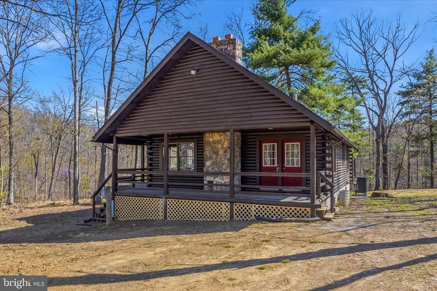 CABIN IN THE WOODS  make this 3-bedroom 2-bathroom log cabin home on just over 3 acres your full-time or part time residence. This fully renovated home features an open floor plan combining the living/dining/kitchen with cathedral ceilings and a woodstove in the living room making it spacious for the perfect cabin feeling. The home has 2 bedrooms and 1 bathroom on the main floor and a private loft bedroom and bathroom on the second floor. The basement is finished, having a family room with woodstove for extra space to entertain or just hang with the family and a bonus room to make what you want. Located less than 2 hours from Baltimore, MD & Washington, DC makes it a perfect weekend getaway. It's also within 15 minutes of the Historic Town of Bath in Berkeley Springs, WV and only 30 miles from Whitetail Ski Resort. Be ready for this one, it may go fast. Professional Photos before going Active.