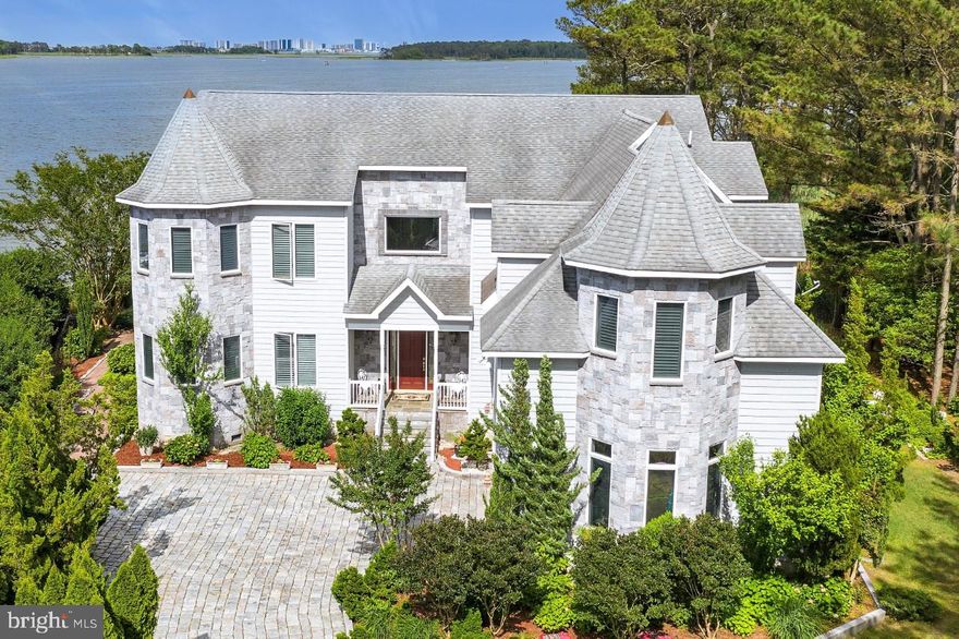 Welcome to your own Private Paradise! Known as the Castle House, this stunning residence is sited at the mouth of the St. Martins River and overlooks Isle of Wight Bay with stunning views of the Ocean City Skyline in the distance. Walk down your private sandy beach to the 120 foot pier with boat lift and spend the day cruising the bay, visiting the many bay side restaurants and bars. For the fishing enthusiast the nearby in-shore and off-shore waters will not disappoint. You may not want to leave this private estate with all it has to offer, gourmet kitchen, exceptional rooms for entertaining, expansive waterfront views, 5 bedroom suites and 1  huge dormitory style room for the kids that sleeps 8, 6 and one half baths, beautiful finishes including Swarovski Crystal Chandeliers and cabinet knobs. Step out onto the huge rear deck and take a swim in the 30x18 pool. Enjoy watching wildlife? This home boarders 10 acres of forest preservation! Located in the prestigious community of Harbor Village in Ocean Pines, this residence is just a few short hours from the DC and Baltimore metro areas. Please contact agent for a detailed list of features and for your private tour of this amazing property.