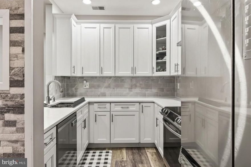 Totally renovated from top to bottom in 2022, the seller spent $50k in upgrades to make this 2-bedroom, 2-bath condo beautiful and move-in ready.  And as an added convenience, no stairs! The beautifully updated interior features a stunning modern kitchen with white 42-inch cabinetry, quartz countertops, stone backsplash, and stainless-steel appliances. Luxury vinyl plank flooring flows seamlessly throughout the entire home, including both bedrooms, complemented by paint and contemporary finishes and fixtures throughout.
The spacious primary suite offers a walk-in closet and an updated en-suite bath with a new vanity and quartz countertops. Both bathrooms showcase elegant white stone tile and stylish upgrades. Enjoy cozy evenings by the fireplace or unwind in the bright and airy sunroom overlooking the private outdoor patio. Additional highlights include generous closet space, abundant natural light, and thoughtfully designed living areas ideal for both everyday living and entertaining.
Linden at Fair Ridge is a beautifully maintained community offering exceptional amenities, including a clubhouse, outdoor pool, tennis and pickleball courts, tot lot, and fitness trail. The unit also comes with one assigned parking space plus ample guest parking throughout the community.
Conveniently located near Fair Oaks Mall, Fairfax Corner, shopping, restaurants, and major commuter routes including Route 50, I-66, and Route 28, and minutes from Washington Dulles International Airport, the Vienna Metro, and DC!