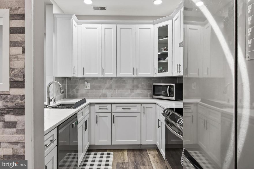 Totally renovated from top to bottom in 2022, the seller spent $50k in upgrades to make this 2-bedroom, 2-bath condo beautiful and move-in ready.  And as an added convenience, no stairs! The beautifully updated interior features a stunning modern kitchen with white 42-inch cabinetry, quartz countertops, stone backsplash, and stainless-steel appliances. Luxury vinyl plank flooring flows seamlessly throughout the entire home, including both bedrooms, complemented by paint and contemporary finishes and fixtures throughout.
The spacious primary suite offers a walk-in closet and an updated en-suite bath with a new vanity and quartz countertops. Both bathrooms showcase elegant white stone tile and stylish upgrades. Enjoy cozy evenings by the fireplace or unwind in the bright and airy sunroom overlooking the private outdoor patio. Additional highlights include generous closet space, abundant natural light, and thoughtfully designed living areas ideal for both everyday living and entertaining.
Linden at Fair Ridge is a beautifully maintained community offering exceptional amenities, including a clubhouse, outdoor pool, tennis and pickleball courts, tot lot, and fitness trail. The unit also comes with one assigned parking space plus ample guest parking throughout the community.
Conveniently located near Fair Oaks Mall, Fairfax Corner, shopping, restaurants, and major commuter routes including Route 50, I-66, and Route 28, and minutes from Washington Dulles International Airport, the Vienna Metro, and DC!