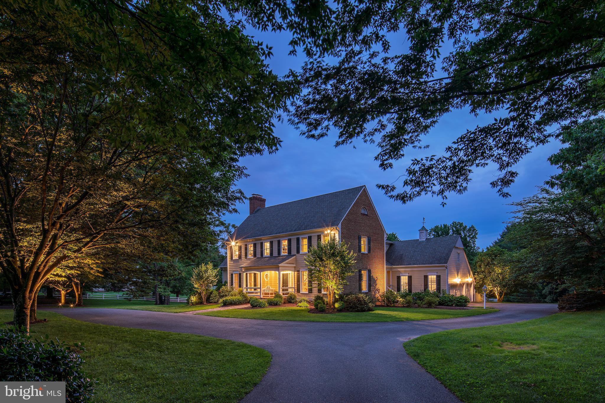 Magnificent colonial perfectly perched on a 2-acre lot with a circular driveway and sparkling pool with a retractable cover! Expertly crafted by master builder John DuFief Sr., this classic New England-styled home showcases his fine quality of construction and meticulous eye for detail. Set on an idyllic and private lot with sprawling lawns and ample parking; this home is perfect for indoor and outdoor entertaining! The gracious stone foyer with a powder room opens to the formal living room, dining room, and warm family room. The recently remodeled kitchen features custom cabinetry, stone tops, tile backsplash, stainless Miele, SubZero, and Thermador appliances, a beautiful butlers' pantry, and a sunny breakfast room overlooking the pool with a retractable autocover. A mud room/laundry room is adjacent to the butlers' pantry and provides access to the oversized 3-car side load garage. The family room is stunning, with a coffered ceiling, gas fireplace, and French doors to the awning-covered Trex deck. The richly appointed library with bookcases, a bar sink, another gas fireplace, and French doors to the deck completes the main level. The upper level features four roomy bedrooms, three full baths, hardwood floors throughout, and a new en suite bath. The primary suite has a wood-burning fireplace, French doors to a serene screened porch overlooking the pool, a dressing area with two walk-in closets, and a lovely bath with a dual sink vanity, soaking tub, and private commode and stall shower. A cedar closet & large linen closet finish this floor. The daylight walkout lower level has a guest room with a full bath, wet bar area, enormous rec room with fireplace, bonus space/game room area, ample storage, and French doors to the covered stone patio. This superlative custom home is near Glenstone Museum and enjoys the amenities of Potomac Village, nearby Shady Grove Hospital, Traville Gateway, and several area golf courses. New since October: all chimneys were re-lined (6 flues), lots of fresh paint, refinished hardwood floors on main/upper levels, new LL bath & engineered floors on the lower level, and recent clear well/septic/termite & radon system. This home is pristine and ready to welcome you!