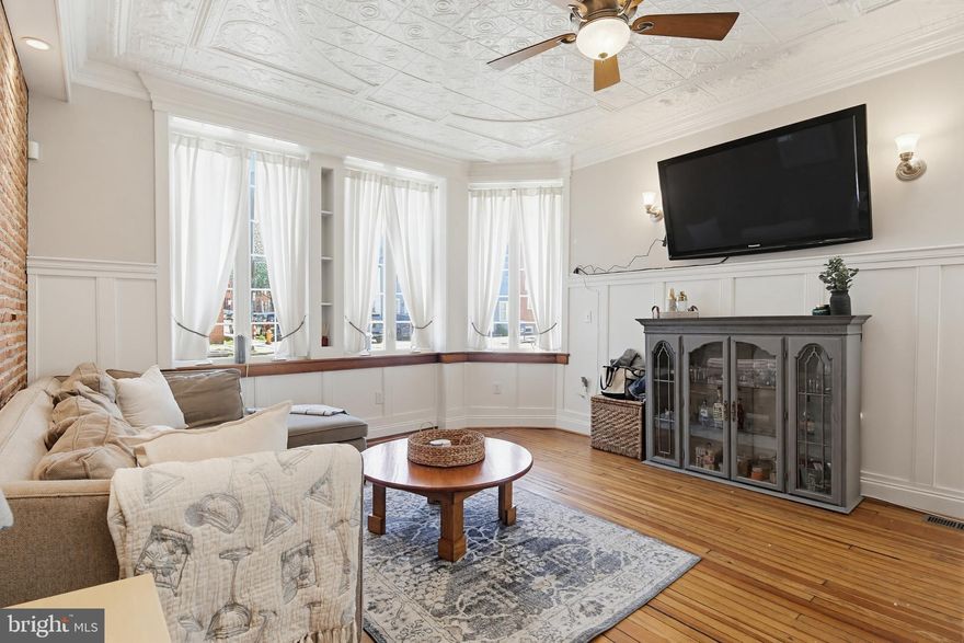 Welcome to 1748 S Charles Street! A beautifully renovated 4-story home by John Bolster, featuring 4 bedrooms and 3.5 baths on a sought-after corner lot, complete with spacious living areas and modern amenities. An attached 2-car garage and rooftop deck make this property a standout in the area!

The main level blends modern updates with historic charm. Timeless trim and architectural details tie the dining area and kitchen together seamlessly. The kitchen features sparkling countertops, sleek stainless steel appliances, and a breakfast bar that adds a casual dining option while enhancing the home’s entertaining space. The living room showcases classic hardwood floors and an exposed brick wall, complemented by updated fixtures and an intricate tin ceiling. Expansive windows line the far wall, filling the space with natural light and creating an airy, inviting atmosphere.

Heading to the second floor, you’ll find the first two bedrooms. The primary bedroom includes a large walk-in closet and private access to an outdoor balcony. Both bedrooms offer generous space and private en suite baths, with the laundry room conveniently located between them for added ease.

The third level features the remaining two bedrooms. The third bedroom is expansive, with large windows and a sliding glass door that brings in abundant natural light and provides access to the balcony, continuing the home’s open and airy feel. The fourth bedroom is across the hall, just past the shared full bathroom, which includes a full-sized tub and shower combo.

At the top, the rooftop deck offers panoramic city views—perfect for morning coffee or enjoying the sunset over the skyline. This sought-after feature pairs perfectly with the attached 2-car garage, which provides direct access to the main living space—an uncommon find in the area.

The lower level offers additional living space with built-in storage and flexible open areas, along with convenient access to utilities and extra storage.

Ideally located in the heart of Federal Hill, this home offers unbeatable access to some of Baltimore’s best dining, nightlife, and outdoor spaces. Enjoy being just steps from Cross Street Market, Federal Hill Park, and the waterfront at Inner Harbor, with convenient access to Oriole Park at Camden Yards and M&T Bank Stadium for year-round entertainment.