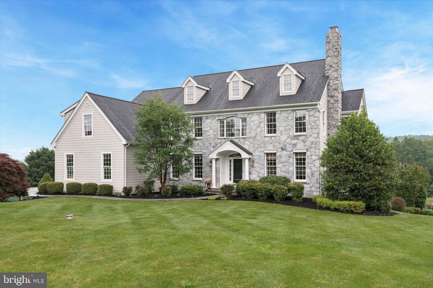 Welcome to this exquisite Traditional home in the prestigious Osborne Place community. This Pocopson Township property sits perfectly at the end of the cul-de-sac in the award-winning Unionville-Chadds Ford School District. Thoughtfully designed for luxury living, this 5 bedroom residence offers more than 6,500 square feet of sophisticated space, including a fully finished daylight lower level, all set on a beautifully landscaped 1+ acre lot.
From the moment you enter the grand two-story foyer, the home impresses with wide-plank wood floors, a grand center staircase, and timeless architectural details. The formal living and dining rooms are perfect for entertaining - featuring crown molding, wainscoting, a gas fireplace, and generous proportions. The heart of the home is the designer kitchen—where beauty meets function. Calming blue and white cabinetry, quartz countertops, a farmhouse sink, custom backsplash, and premium appliances create a space as practical as it is elegant. The breakfast area flows seamlessly to the deck, while the adjoining family room offers vaulted ceilings, a wood-burning fireplace, custom power shades, and walls of windows overlooking the backyard retreat. A private first-floor office offers the ideal work-from-home setup, complete with custom built-in shelving and French doors. The bright and airy sunroom—featuring vaulted ceilings and access to the deck—adds a serene space for reading or relaxing. A powder room, mudroom with built in storage cabinets for extra organization, and rear staircase complete the main level.
Upstairs, the luxurious primary suite includes a sitting room with fireplace, tray ceilings, a custom California walk-in closet, and a spa-style bath with soaking tub, glass-enclosed shower, dual vanities, and private water closet. Four additional spacious bedrooms, two full bathrooms, a laundry room, and an open loft/homework station complete the upper level—perfectly balancing space, privacy and comfort for every member of the family. The finished walkout basement is a true extension of the home, offering a large recreation area, fitness room, guest suite potential (6th bedroom), full bath, and ample storage—ideal for hosting, relaxing, or play.
You will fall in love with the backyard as you step outside to your private resort-style oasis. The view is incredible! The fenced-in saltwater pool and spa are surrounded by professional hardscaping, patios, and lush mature landscaping—offering both beauty and function for gatherings or peaceful family weekends.
Luxury Features & Recent Updates Include: 3-car garage & extended driveway for ample parking, Whole-house generator, New roof & garage doors (2021), Three Lennox HVAC systems (2018, 2018, 2022), HardiePlank siding & stucco remediation (2020), Designer kitchen remodel & woodwork updates (2020), California Closet in primary suite (2014), Saltwater pool & spa installation with landscaping (2008), New driveway (2018), water filtration system.
This exceptional home blends timeless elegance, thoughtful updates, and family-centered functionality. Whether entertaining guests, working from home, or enjoying a peaceful day poolside, 116 Osborne Circle offers an unparalleled lifestyle in a premier Chester County location. This is the forever home you’ve been waiting for.