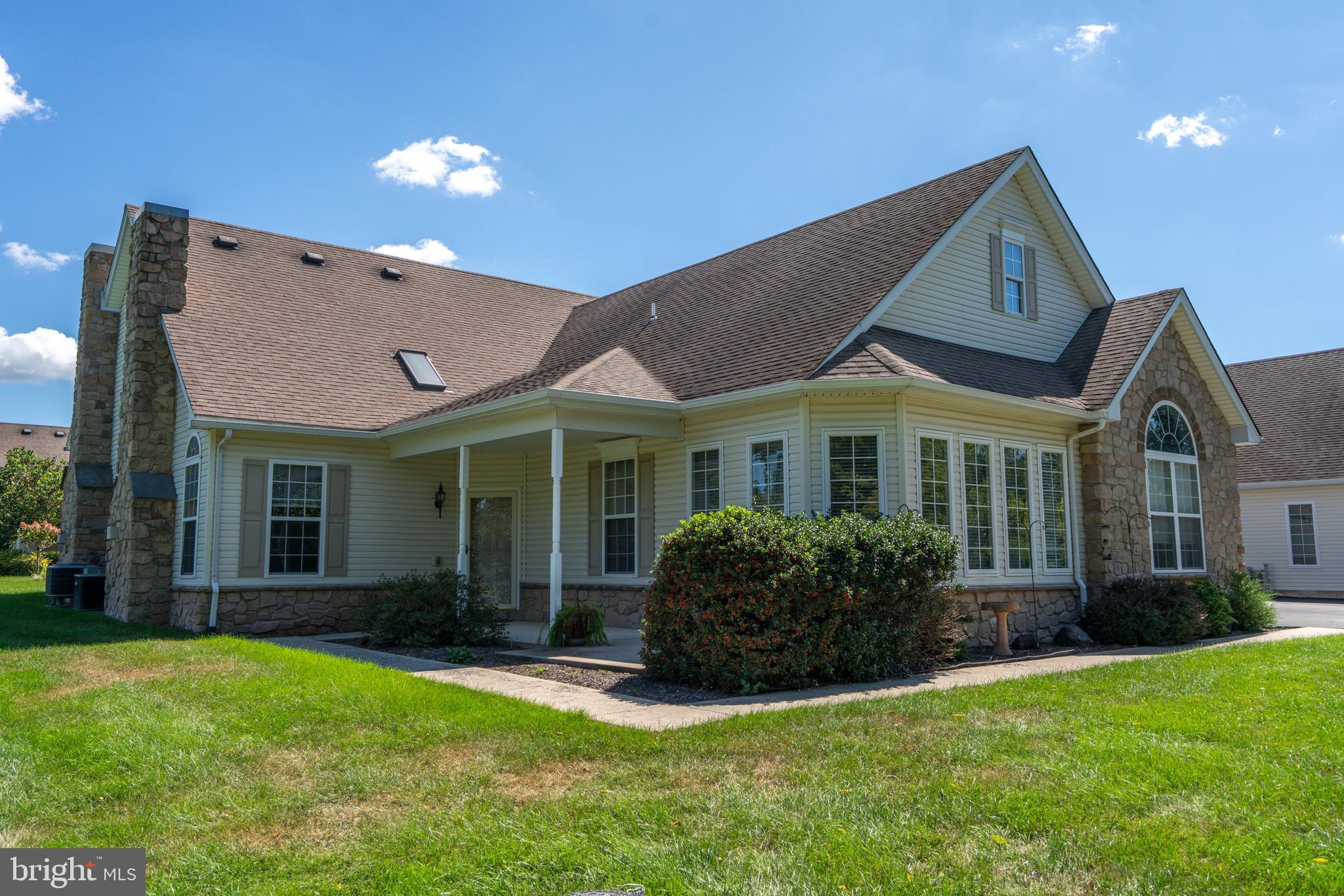Settle into a relaxing lifestyle in this popular Concord model located in one of the more private locations in the Vineyards community in Pennsburg. The welcoming open floor plan features wider plank hardwood floors throughout the first floor. The spacious great room is warmed by a floor to ceiling fireplace, palladium windows, and recessed lighting. The versatility of this model allows for a dining area adjoining the living room area, or in a separate adjacent room across from the kitchen. This room, framed by French doors, could also serve as a den or home office. Through another set of French doors is the sunroom featuring a tile floor and two walls of windows providing an abundance of light during bleak winter days. The generous sized kitchen, with room for a table, provides an abundance of cabinets with crown molding, over and under cabinet lighting, recessed lights, and stainless steel appliances and sink. Down the hallway you’ll find the primary bedroom with recessed lighting, a large walk-in closet and en suite bathroom complete with a heat lamp for those chilly mornings. Also on this floor is a convenient half bath, coat closet, and laundry area. The second floor features the second bedroom with a large walk-in closet and a full bath for the privacy and comfort of your guests. This room could also serve as an exercise room, TV room, or a space for your hobbies, and the bathroom has a jetted tub to relieve your aches and pains after exercising! Each room of this home except for the kitchen has a ceiling fan to efficiently and economically circulate warmed and cooled air. The attached two-car garage has plenty of shelving for storing household supplies and room for sporting equipment. Outside, this home’s location within the community provides plenty of space for entertaining and lawn games and is steps away from the walking path.
The Vineyards community is secured by a gated entrance and has a clubhouse with fitness room, game room, library, and kitchen. There is also a wonderful scenic paved walking path throughout the community for you and your four-legged companions, and tot lot for those visiting grandchildren. Located in a lovely rural setting yet convenient to shopping, medical facilities, recreational areas and tourism destinations including Montgomery County’s Green Lane Park, with easy access to major transportation arteries. One -year APHW Home Warranty provided to buyer.