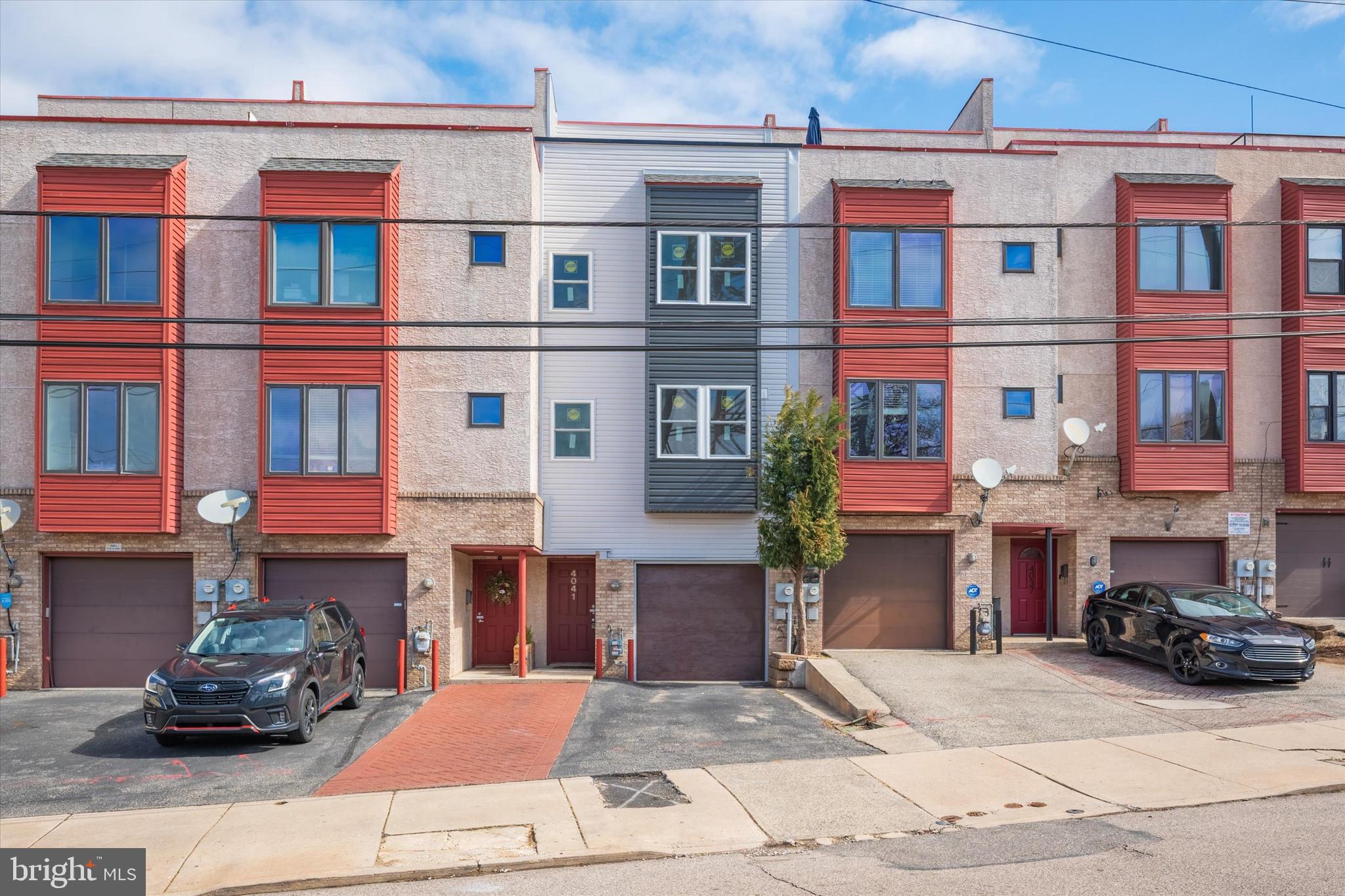 Stunning Contemporary Townhome in the Heart of Manayunk – With Parking! Nestled in the prime location of Manayunk, just one block from vibrant Main Street, this stylish and spacious townhome offers the perfect blend of modern comfort, convenience, and charm. Enjoy effortless access to an array of boutique shops, acclaimed dining, and seamless public transportation into Center City and beyond. Say goodbye to parking woes! This home includes an attached garage and a driveway with space for two cars—a rare and coveted feature in this sought-after neighborhood. Exceptional Interior Living Space Step inside to discover an expansive living area boasting 14-ft ceilings, elegant bamboo flooring, and a cozy fireplace—all bathed in natural light streaming through gorgeous French doors. These doors open onto your private and spacious patio, the perfect spot for morning coffee, al fresco dining, or summer grilling. flow seamlessly into the large dining area, ideal for entertaining, and an upgraded chef’s kitchen featuring granite countertops, ample wooden cabinetry, modern appliances, and a convenient breakfast bar. Spacious and Thoughtfully Designed Bedrooms On the second floor, you’ll find two generously sized bedrooms, each offering walk-in closets, warm wood flooring, and large windows that flood the rooms with natural light. The hall bath is elegantly designed with modern finishes and sleek stone tile flooring. This floor also houses a laundry room for ultimate convenience. The third floor is your private retreat—a spacious primary suite with a walk-in closet and a spa-like ensuite bathroom featuring dual vanities, a glass-enclosed stall shower, and a luxurious soaking tub. But the true showstopper? The expansive rooftop deck! This incredible outdoor oasis provides breathtaking views of Manayunk and beyond, making it the perfect place to unwind, entertain guests, or soak in the city skyline. Prime Location – Walkable & Convenient. Enjoy all that Manayunk has to offer just steps from your door! Walk to local favorites like The Brass Tap, The Rook Manayunk, Manayunk Brewing Co., and The Goat’s Beard. Grab an ice cream at Chloe’s Corner, or head to the Wissahickon Bike Trail for a scenic ride or walk. Need to commute? The Regional Rail, Ridge Ave., and City Ave. provide easy access in and out of the city. This home is move in ready with 10 year transferable warranty on the brand-new windows, recently installed roof deck, and all new fresh siding. Don’t miss the chance to own a spacious, stylish townhome with parking and private outdoor space in one of Philadelphia’s most charming and dynamic neighborhoods.