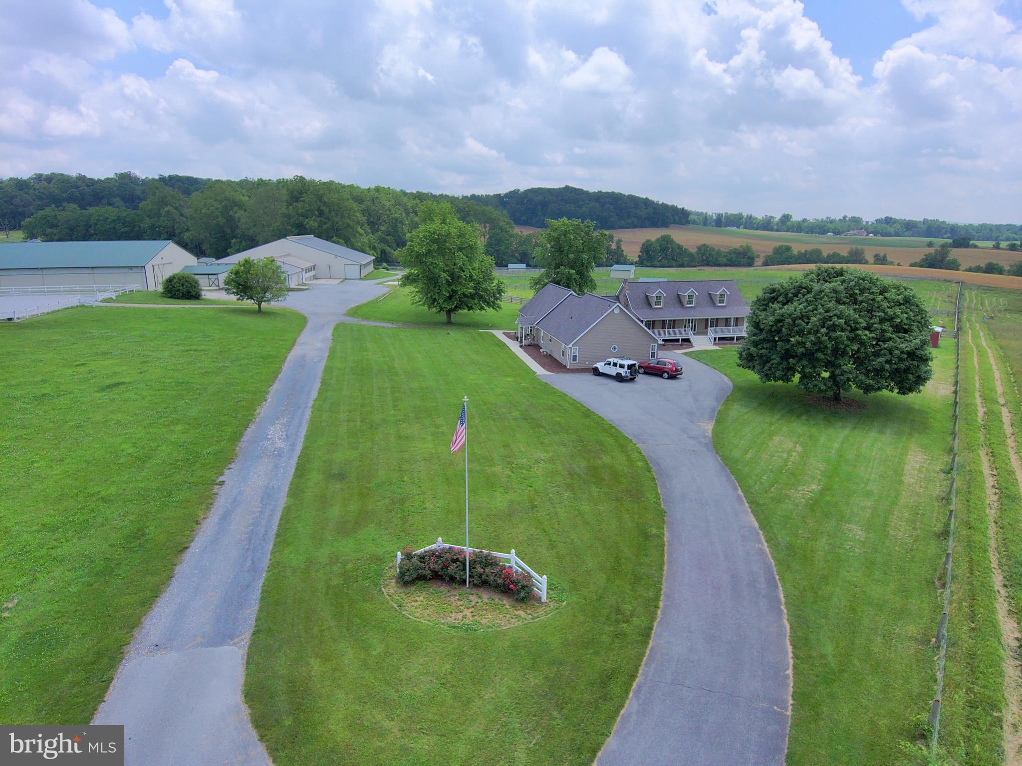 Premier Equestrian Center on 50 Scenic Acres — Featuring Two Full Residences
This state-of-the-art, full-service equestrian facility is a rare turnkey opportunity for serious equine professionals or aspiring entrepreneurs. Situated on 50 picturesque acres, this meticulously upgraded property offers everything you need to board, train, host clinics or shows, and build your dream career in the equine world.
Residences:
Main Farmhouse plus Full-Size Attached In-Law Suite — two complete homes perfect for multi-generational living, staff housing, or rental income.
Equestrian Facilities:
Arenas & Riding Areas
200x80 Indoor Arena with brand-new LED lighting, climate-controlled viewing/judges room with A/C, heat, and sound system for announcements and music.
200x100 Outdoor Arena with lighting and water hydrant.
Grass Dressage Arena with integrated obstacle course.
Stabling & Barn Amenities
29 numbered 12x12 stalls in spacious indoor barn
5 grooming stalls + 4 hot/cold water wash stalls in dedicated wash building
Heated/A/C Tack Room with 29 lockers and ceiling fans
Owner’s Office with new flooring, A/C, heat, and Wi-Fi
Boarders’ Lounge with kitchenette (granite counters), ceiling fans, and half bath
Feed/Employee Room with built-ins, new lighting, A/C & heat, fridge, wash sink, and potential upstairs apartment
Pasture & Turnout
19 fenced paddocks with run-in sheds and automatic waterers (designed to open into larger pastures)
7 additional acres of fenced pasture
New 4-board fencing with electric and all-new gates
Additional Features:
3-Bay Garage / Hay & Equipment Barn with 12x12 doors, electric, and lighting
Tool Shed with new roof, siding, and electric
Outdoor Wash Stall
24 lockers for field boarders
6 Big Ass Barn Fans
Security Camera System
Custom Barn Doors
Manure Pit
4 exterior hydrants around the barn
Two 50-amp RV hookups
All-new exterior lighting
Potential for future cross-country course
This exceptional facility has been fully updated over the past five years and is ready for immediate operation. Whether you’re looking to run a boarding business, training program, show series, or clinic venue, this property offers unmatched versatility and income potential.
Build your equestrian legacy here — the possibilities are endless!