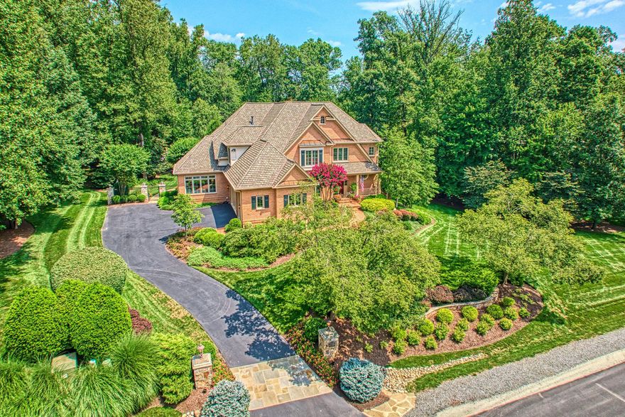 A HOME WITHOUT COMPROMISE! Originally built in 2001, this exquisite home has been expanded/rebuilt presenting today in nearly new condition with remarkable craftmanship and attention to detail throughout.
MAIN LEVEL: Presents a formal living room w/ a dramatic open ceiling, gas FP, architectural archways opening to a banquet-size formal dining room w/ coffered ceiling. The spectacular chef-quality kitchen renovation (2021) features Wolf/Sub-Zero/Cove appliances   2 dishwashers, 3 ovens, a 6-burner range w/ griddle, 48-inch side-by-side refrigerator, under-counter beverage refrigerator & ice maker. Custom inset Wood-Mode cabinetry extends to full ceiling height & is paired with an oversized center island featuring striking Quartzite countertop.

The  morning room adjacent to the kitchen opens to the family room w/ gas fireplace w/ white marble surround & custom raised panel millwork & opens to the sun room enhanced with architectural moldings, trim, & refined sconce lighting.

Designed in Lowcountry style, the 23x23 screened-in porch extends the home’s living area while maintaining connection to the surrounding landscape. A vaulted, cathedral wood ceiling w/ windowed cupola & LED lighting is breathtaking. The adjacent outdoor kitchen offers a Kalamazoo Gourmet Grill & Pizza oven, frig & hot/cold water sink. This is a must see!

BEDROOM LEVEL: Features 4 bedrooms & 3 fully remodeled baths. Custom vanities, designer mirrors & lighting, premium Kohler brushed Nickel fixtures add timeless quality. The primary bath has been beautifully renovated w/  custom digital, rimless glass-enclosed shower w/ heated floor, custom double vanities w/ integrated low level accent lighting providing both subtle illumination & a refined architectural effect.

LOWER LEVEL: The sun filled, walk-out lower level has been expanded (2014) to include an elegant study/guest suite/au pair suite complete with wood flooring, a full bath w/Travertine tile, rimless glass shower door & a custom made vanity. The separate entrance provides seamless access to the landscaped grounds. To complete the lower level there is a large recreation room with a stone-walled fireplace,  a true coffered ceiling, a billiard room, a home theater w/ wet bar and a 5th bedroom and  full bath.

RESORT-STYLE POOL & GARDEN GROUNDS:(2014) Almost 2 acres of privacy is centered around a heated saltwater pool & heated relaxation pool. Fountains, water features & ambient lighting add movement & atmosphere. Stone pathways guide you through beautifully landscaped gardens, filled w/ perennials, ornamental grasses, & flowering plantings. Green Giant Arborvitae form a natural privacy screen enhancing the sense of tranquility  & seclusion. Additional landscape elements include a charming pergola, a rose garden, a striking 3-tier fountain, all supported by a full irrigation system & low-voltage landscape lighting on programmable timers.
 
TECHNOLOGY, SECURITY AND HOME SYSTEMS: A comprehensive ULTRA-GUARD security system includes high-definition cameras, crash and motion detectors, smoke, heat & carbon monoxide detectors on all floors, & water sensors located near key plumbing areas. All mobile app controlled. Connectivity is  VERIZON fiber-optic service including a whole-house surge protector. There is a  4-zone HVAC system, including 2 TRANE natural gas systems, a steam-injected humidifier, 3 Enviro Air UV light air cleaners, 3 Lennox E30 touchscreen thermostats (2021), a Trane heat pump, a Lennox split-unit, ensuring efficient & precise climate control throughout.
The home is ALL BRICK, approx. 8000 sq ft.