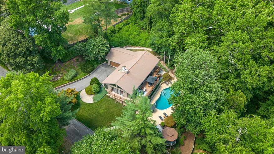 **May 3rd Open House CANCELED - PROPERTY IS UNDER CONTRACT** Welcome Home to Rivendell! Prepare to be wowed by this modern contemporary home with a two car garage offering water views, easy access to the community pier plus your very own private backyard oasis. Entertain this summer in the in-ground pool or host BBQs on the expansive deck and private gazebo overlooking the pool and the water beyond. Perfectly perched at the end of a quiet street in the heart of Severna Park with easy commuter access and just a short drive to local restaurants, shops & entertainment. Step inside to custom, high end finishes throughout. A newly renovated chef inspired designer kitchen complete with large center island, luxury stainless steel appliances, gorgeous tiled backsplash all open to the formal dining room and great room beyond. Soaring, vaulted ceilings in the great room with walls of windows looking to the water fill the space with tons of natural light. Sliding doors offer seamless access from inside to out, making the home perfect for entertaining. A main level primary suite is the perfect place to unwind- built with relaxation in mind. This spacious room has sliding doors to the deck, ample closets and a stunning, newly renovated custom en suite bathroom with dual sink vanity and glass enclosed tiled shower. Travel to the lower level to find a wonderful rec room with a second cozy fireplace and 3 additional generously sized bedrooms, a home office, an updated full bathroom and slider door access to the patio and pool beyond. There's no shortage of space with ample closet and storage space. Severna Park Blue Ribbon Schools. Schedule your private tour today!