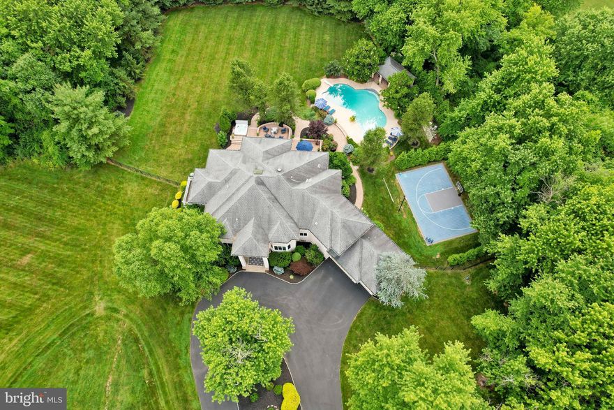 Discover unparalleled luxury and indoor/outdoor living at this exceptional contemporary estate, encompassing nearly 5 acres of meticulously manicured grounds in the highly sought-after Council Rock School District. Boasting over 8,000 finished square feet, this home is an entertainer's dream, featuring a basketball court, sparkling pool, poolside gazebo and expansive hardscaping complete with a sunken hot tub. Enjoy the convenience of public water and sewer, and the unbeatable location within walking distance to Hillcrest Elementary and Holland Middle School.

Step inside through custom Italian wrought iron doors and be captivated by the abundance of natural light cascading through the home's contemporary design. The gourmet eat-in kitchen, equipped with a Sub-Zero fridge, island and butler's pantry,  is a chef's delight. Complemented by a grand 2-story family room with a Juliet balcony and numerous windows and sliding glass doors to the rear patio. Along with a spacious office, with wall-to-wall built ins. Dual staircases lead to both levels, enhancing the home's seamless flow. The primary suite is a true retreat, offering a private balcony and a luxurious bathroom with heated floors. The remaining spacious bedrooms have walk-in closets and are paired with multiple Jack-and-Jill bathrooms providing added convenience for family and guests.

This home is designed for ultimate comfort and entertainment. The finished walk-up basement, complete with a full wet bar and full bathroom, provides endless possibilities for recreation and relaxation. A sunroom offers a tranquil space to unwind, while the laundry chute adds practicality to daily living. Plus a three car garage and recently seal coated circular driveway with endless parking. Recent upgrades include newer oversized gutters, newer multi-zone HVAC,  newer heat pump hot water tank, along with a backup generator and speaker system ensure year-round comfort and peace of mind. 

Best of all is the combination of privacy and convenience. While centrally located close to major roadways, regional rails, schools and more, you are nestled in a completely private retreat! Call today to explore the limitless possibilities this majestic estate has to offer!