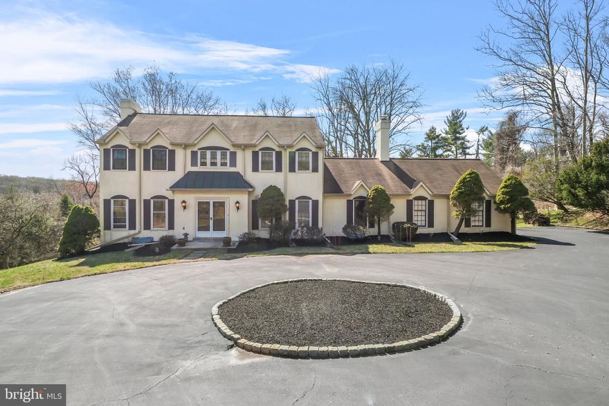 Welcome to 455 Hughes Road, a charming 4-bedroom, 2.5-bath center hall colonial, nestled on a private 1.2-acre lot in the highly sought-after Gulph Mills neighborhood. Set back from the road, this home is accessed via a circular driveway, ensuring peace and privacy.  As you step through the double doors, you're greeted by a spacious foyer. To the left, a bright and airy living room features an abundance of natural light, a  fireplace, and sliding doors that lead to a back deck, perfect for relaxation or entertaining. To the right, the formal dining room offers beautiful built-in cabinetry and ample space for hosting elegant dinners.  The eat-in kitchen is equipped with a pantry, island, and a cozy dining area. Sliding doors open to a rear deck, creating a seamless connection to the outdoors. Adjacent to the kitchen, a welcoming family room with another fireplace provides additional comfort and direct access to the patio. This creates an ideal setting for indoor-outdoor living, all while enjoying views of the beautifully landscaped yard, mature trees, and lush plantings.  Completing this level are a convenient half bath, a laundry room, and direct access to the 2-car garage.  On the second floor, the spacious primary suite offers a walk-in closet and an en-suite bath. Three additional generously sized bedrooms share a full hall bath. An attic space is also accessible from this level, providing ample storage.  The large walkout basement offers even more potential for additional living space.  Additional highlights include hardwood floors throughout, a new heater (2024), and a newer hot water heater (2020). This home is brimming with potential – bring your personal style and creative touch to make it truly your own.  Conveniently located near shopping, dining, and entertainment in King of Prussia, Radnor, and Wayne, with easy access to major highways and SEPTA, this home offers the perfect combination of tranquility and convenience. Situated in the highly rated Upper Merion School District, 455 Hughes Road is truly a unique find. Don't miss the chance to see it – schedule your tour today!