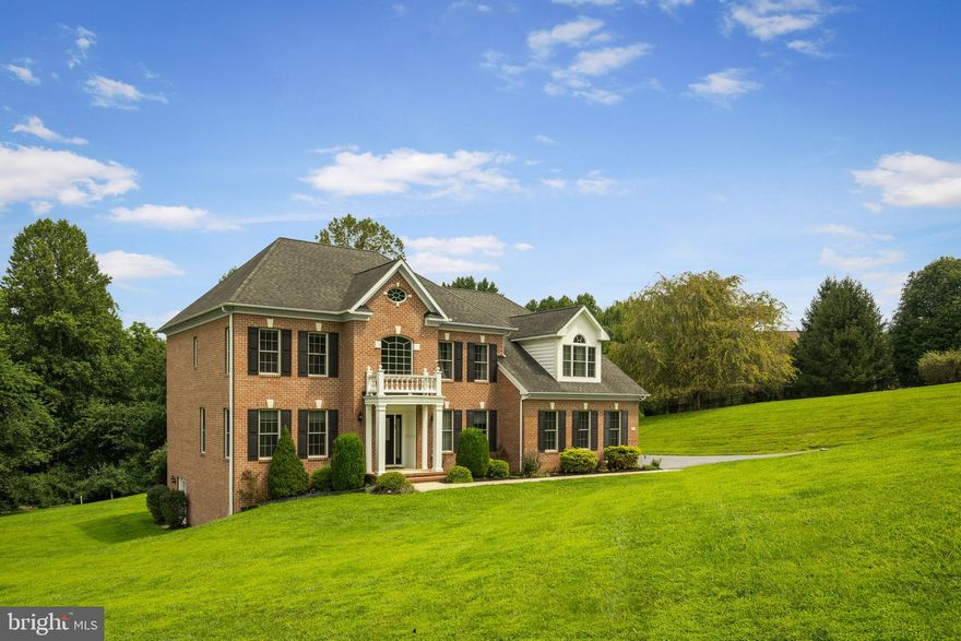 Welcome to 5 Fox Field Court, a timeless all-brick colonial tucked away at the end of a quiet cul-de-sac in one of the area’s most picturesque communities. Set on more than four acres of landscaped grounds, this home blends classic architecture with modern updates, offering over 5,000 square feet of comfortable and stylish living space. The dramatic two-story foyer fills with natural light, highlighting hardwood floors and detailed trim work. A private office sits to one side, while a formal living room on the other provides the perfect space for gatherings. The gourmet kitchen is the heart of the home, featuring stainless steel appliances, granite countertops, gray cabinetry, and a designer backsplash. The sunny breakfast nook flows into a warm family room with a brick fireplace. Hosting special occasions is easy in the formal dining room with crown molding and chair rail accents. A powder room and laundry area complete the main level. Upstairs, the primary suite is a retreat with hardwood floors, dual walk-in closets, a gas fireplace, and a spa-like bath with soaking tub, dual vanities, and glass shower. Three additional bedrooms and two full baths provide generous space for family and guests. The finished lower level offers a second family room, large recreation space with a custom wet bar, a bonus room, full bath, and plenty of storage. Step outside to enjoy a stone patio, freshly painted multi-level deck, and hot tub. A peaceful creek runs along the back of the property, while an oversized two-car garage and spacious driveway provide ample parking. Recent updates include: deck painting (2025), well tank (2024), second-floor AC (2024), refrigerator (2023), hot tub (2022), stone patio and landscaping (2021), radon system (2021), full kitchen renovation (2020), new carpet (2020), Generac generator (2020), and security system (2020). 5 Fox Field Court is more than a home. It is a lifestyle of comfort, privacy, and refined living.