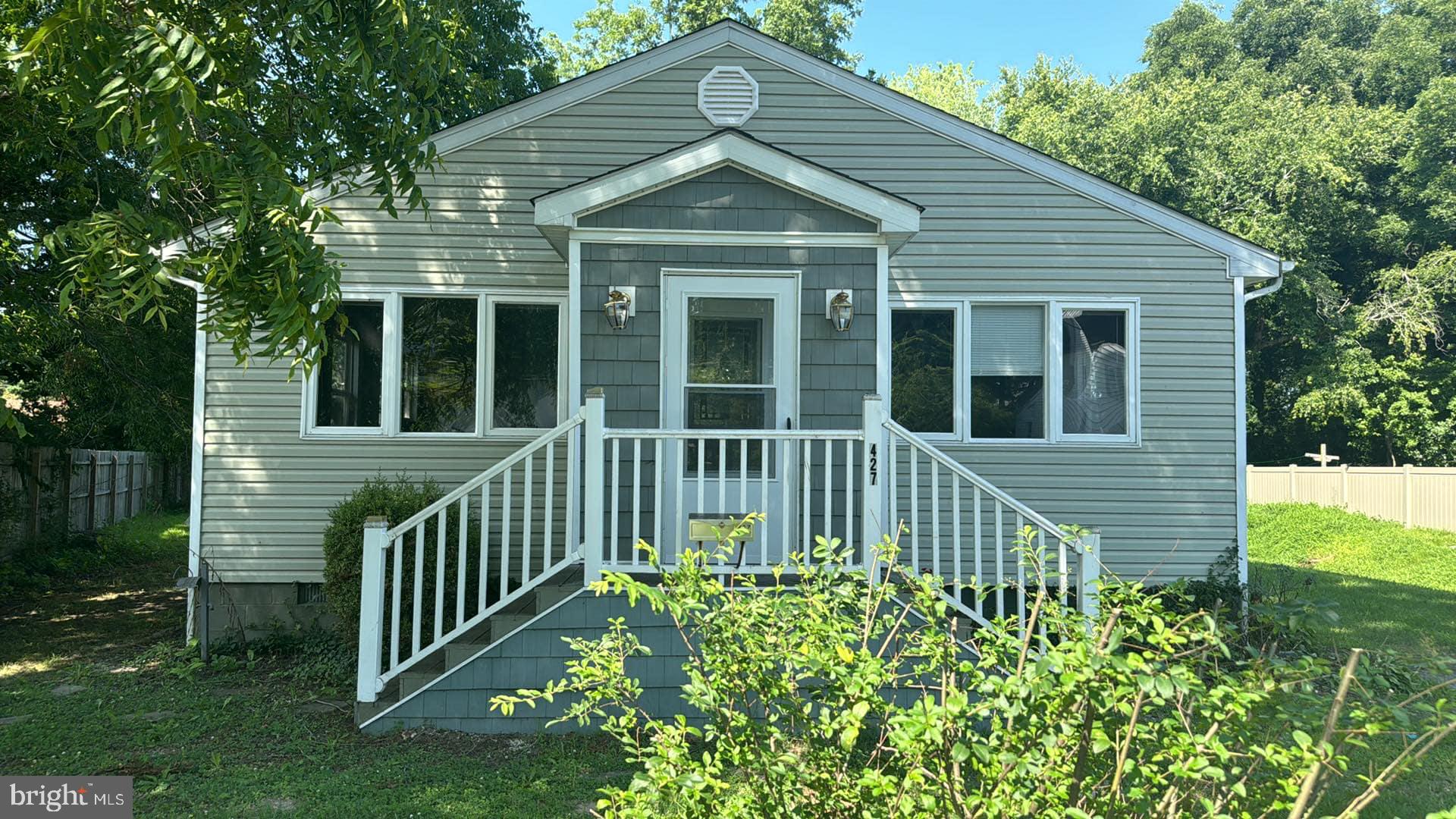 This beautiful home features a spacious, open floor plan that creates a warm and inviting atmosphere. It includes two comfortable bedrooms and one and a half bathrooms, perfect for everyday living. The master bedroom boasts high ceilings and sliding glass doors that provide easy access to the porch, enhancing the sense of openness and connection to the outdoors. The nearly wrap-around porch offers plenty of space for relaxing, entertaining, or enjoying the fresh air. Additionally, the property includes a detached one-car garage , adding convenience and additional storage options. Overall, this home combines functional design with charming outdoor living, making it a wonderful place to call home.