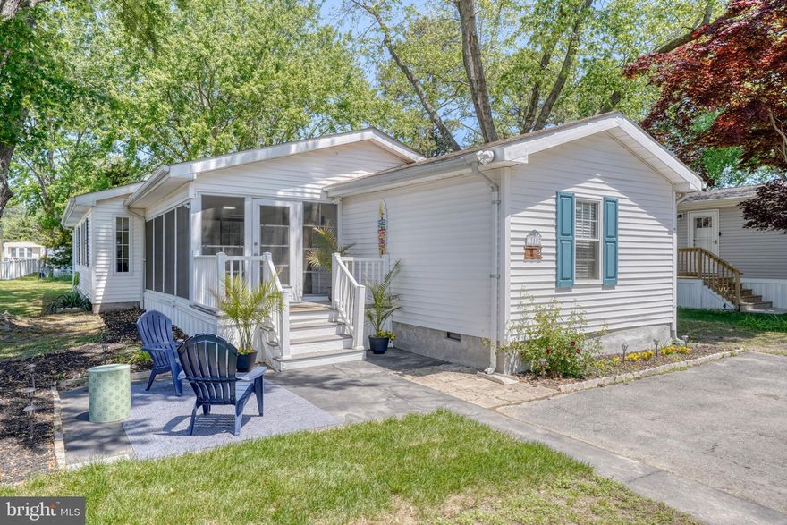 MOVE-IN READY IN LEWES! Beautifully renovated 4-bedroom, 2-bath ranch-style manufactured home on a permanent foundation located in the waterfront community of Angola Beach & Estates. This bright and inviting home features vaulted ceilings and an open-concept layout connecting the kitchen, living, and dining areas. The fully updated kitchen showcases all-new shaker-style wood cabinetry, quartz countertops, quartz backsplash, new stainless-steel appliances, and bar seating for four. Additional recent improvements include laminate flooring throughout (with much of the subfloor also replaced), updated bathrooms with custom tile finishes, all new lighting fixtures, fresh interior paint, electric heat cables to prevent frozen pipes, newer windows, and newer HVAC. The spacious primary suite offers double closets and a luxurious ensuite bath complete with dual vanity, rainfall showerhead, and custom tilework. The refreshed screened porch features new paint, stain, screens, and lighting — perfect for relaxing summer evenings. A newly built outdoor shed provides additional storage. Home is being sold mostly furnished with a few exclusions. Residents of Angola Beach & Estates enjoy exceptional amenities including two swimming pools, floating marina with boat ramp, fishing and crabbing pier, kayak and canoe storage, fenced RV/boat/trailer storage, basketball and tennis courts, playgrounds, riverfront park, and a community center with planned resident activities. Land lease is $750/month and includes water, sewer, and trash service. Residency is subject to community approval, including credit, background, and income verification. Perfect as a full-time residence or coastal getaway. Located within Cape Henlopen School District and ideally situated just 10 miles from both Lewes Beach and Rehoboth Beach. Enjoy everything coastal Delaware has to offer, including local restaurants, shopping at Tanger Outlets Rehoboth Beach, outdoor recreation at Cape Henlopen State Park, boating, fishing, and more.