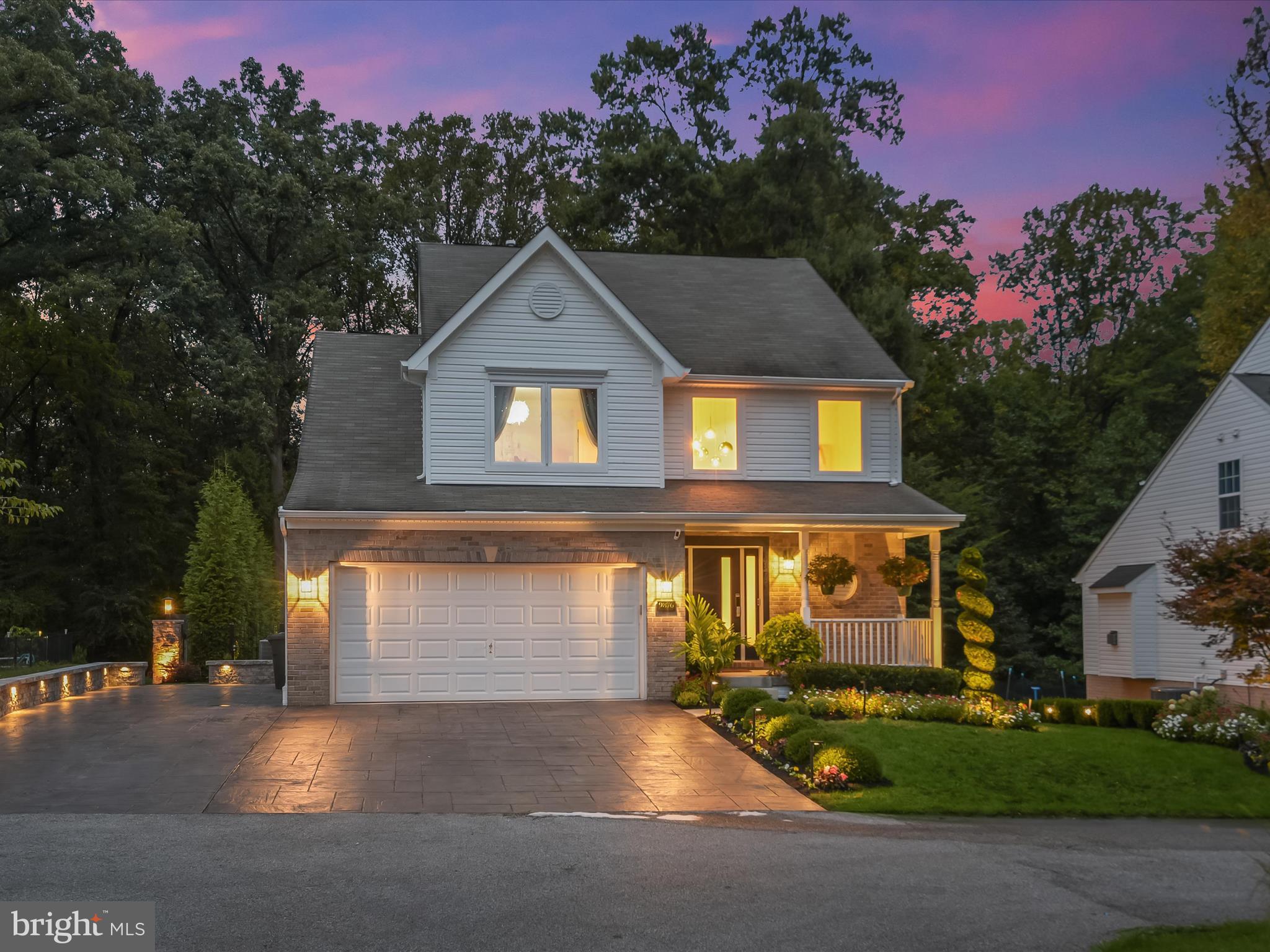 Set against a serene backdrop of mature woods and impeccably maintained landscaping, this extraordinary residence offers an oasis-like retreat, with four bedrooms, three and a half bathrooms, and three levels of refined living where modern luxury meets timeless design. Every detail reflects exceptional craftsmanship, with custom finishes throughout, a neutral palette, and thoughtful touches such as remote-controlled draperies and dimmable lighting. A dramatic two-story foyer welcomes with abundant natural light, a built-in bench, and striking modern fixtures. At the heart of the home, the gourmet chef’s kitchen pairs functionality with elegance, showcasing imported soft-close cabinetry with under-cabinet lighting, Taj Mahal quartzite counters and backsplash, and a waterfall island with seating. High-end JennAir appliances include a five-burner gas range, wall oven, built-in microwave, and coffee station, with hidden dishwasher and refrigerator seamlessly integrated. A potfiller, built-in range hood, and lighted desk nook further elevate the space. Flowing from the kitchen, a bay-window dining area opens to a balcony overlooking the backyard, while the living room boasts lighted built-ins, a bold accent wall, and sliding doors to the patio. Completing the main level are a mudroom, pantry, powder room, and two-car garage. Upstairs, the impressive primary bedroom showcases a soaring beamed cathedral ceiling with a decorative accent wall, two closets including a walk-in, and a dual-sided fireplace shared with the spa-inspired ensuite. A retreat of its own, the bathroom features dual vanities, a skylight, a soaking tub, separate water closet, and an oversized walk-in shower with rainfall head, bench seating, and a lighted niche. Two additional bedrooms accented with custom trim moldings, a hall bathroom with a tub-shower, and a laundry closet complete this level. Downstairs, the finished lower level expands the living space with a recreation room highlighted by a custom wood-slat accent wall and sliding doors to the ground-level patio. A built-in office area provides functionality, while a versatile exercise room doubles as a second office or storage. A fourth bedroom and full bathroom with walk-in shower make this level ideal for guests or extended stays. Outdoor living reaches new heights with a spacious patio off the main level that has built-in outdoor kitchen equipped with a Sunstone Ruby four-burner gas grill, dual-burner cooktop, refrigerator, and sink. The ground-level patio also includes a storage shed. Paradise awaits in the expansive backyard featuring a large pavilion that serves as an inviting space for entertaining, complete with a wood-burning pizza oven, fire pit, and play area. Framed by impeccably designed, manicured landscaping, accent lighting, and an underground sprinkler system, the grounds feel like a private park.