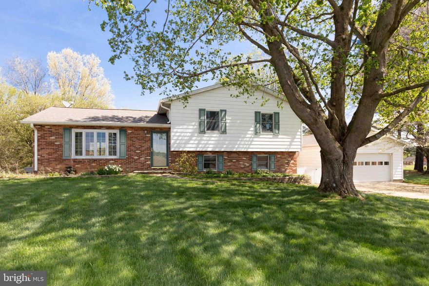 This charming 3 Bedroom, 2.5 Bath home is the one you've been waiting for! It has been meticulously maintained and updated over the years and is located in The Hereford Zone! With its prime location on tranquil Grace Rd and its spacious lot situated on 1.29 acres, this is truly a unique offering. As you approach the home you will notice an attached 2 car garage with adjoining mudroom. There is attention to detail around every corner, with mature landscaping beds and plantings, a flagstone front walk with stacked stone mulched flower beds, and a bucolic view of the surrounding farm fields and countryside from the front yard. Character abounds from the minute you walk inside this home. The gleaming hardwoods in the house have been newly refinished throughout and the bay window in the living room brings tons of natural light into the home. The kitchen is thoughtfully designed and and has a fresh modern feel that opens to the living room and dining space. It features a warm and rustic tile floor, black granite counter tops, beautiful white cabinetry with custom seeded glass, recessed lighting, and a glass cook top. All of the appliances and kitchen sink are stainless steel: a GE Monogram stove, a Bosch dishwasher, and a GE refrigerator/freezer. The primary bedroom is well sized and has custom built-ins with soft close drawers, recessed lighting, a ceiling fan, and an en suite full bath. The en suite bath features a built in vanity and walk in shower. The additional 2 bedrooms are evenly sized with closet space and are conveniently located near the hall full bath. This full bath has a stained glass transom, a built in vanity, and a shower/tub combo. The lower level has brand new carpet and would function as a great club room or entertainment space. Additionally it has custom built in bookcases and a wood burning fireplace to cozy up on those cold winter nights. There is a powder room on that level as well with a built in vanity made from a reclaimed antique cabinet. As you continue through the house the beautiful french doors provide access to the mudroom and garage area-making for ease of living ! The unfinished basement off the lower level is a great bonus area and provides a great storage space with built in shelving or an area for a home workshop. The LG front loading clothes washer and dryer are also located in this space as well. Take in the country views from the rear deck made with premium Ipe decking and a custom stone fish pond with bluestone capping – enjoy the peaceful sounds of the built in waterfall! The level play yard is ideal for all your outdoor activities and garden dreams! Enjoy the ease of country living and take in the sounds of nature from the ample bluestone patio – great for those backyard BBQ's or nights around the fire pit. The property also has an exterior shed for all your storage needs. Notable updates include: Asphalt Roof replacement (2020), a Kholer whole house generator, and a water heater (2017). First showings are available on Friday, April 24th when the listing goes ACTIVE. Open Houses slated for Saturday and Sunday from 12pm-2pm (April 25th and 26th ). Don't let this Hampstead gem pass you by, schedule your tour today!