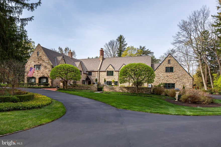 Welcome to Braehead—named for the Scottish phrase “Top of the Bank”—a stunning,
historically envisioned home with timeless elegance and unmatched flexibility. Inspired by
George Washington’s ancestral home, Sulgrave Manor, this meticulously maintained English
Country estate blends rich architectural heritage with modern-day livability.
Originally part of the Schmidt brothers’ estate (of Schmidt’s Brewing Co.), the property was
subdivided during Prohibition. In 1929, the renowned firm Mellor & Meigs designed the home in
the Cotswold cottage style. In 1999, the current owners partnered with architect Daniella Voith
of Voith & MacTavish and builder Mark Hallowell to thoughtfully expand and update the
residence, maintaining its architectural integrity while enhancing functionality.
Set on nearly two acres in a coveted Main Line location, 458 Huston Road offers 6 to 7
bedrooms, 4 full and 2 partial bathrooms, and a 3-car attached garage—a rare combination
of charm, size, and practicality. Except for the first-floor guest bedroom, all other bedrooms are
on the 2 nd floor.
As you ascend tranquil, tree-lined Huston Road, you’re welcomed by a canopy of mature trees
and stately homes. A circular driveway leads to Braehead’s elegant stone façade, framed by
intricate brickwork and lush landscaping. Step through the brick-lined courtyard and ornate front
door into a grand two-story foyer paneled in warm wood—a nod to the home’s historic roots.
The versatile floor plan accommodates both everyday living and entertaining with ease. The
expansive living room opens to a sunlit private office, while the formal dining room and gourmet
kitchen—equipped with abundant cabinetry, a large center island, and granite countertops—flow
seamlessly into a vaulted family room bathed in natural light.
An ideal layout for today’s evolving lifestyles, the main level features a private suite with a
separate entrance, perfect for multi-generational living, guests, a nanny/au pair, or even one
or two work from home offices. This wing includes two upper-level bedrooms, each with
access to a private bath, providing flexibility for changing household needs.
Upstairs, discover 5 additional bedrooms, including the luxurious primary suite with cathedral
ceilings, a fireplace, a room sized closet, 3 more closets, and spa-like en suite bath. A second-
floor laundry room and large walk-in attic offer added convenience and storage.
The partially finished lower level includes a recreation area, gym and abundant storage, adding
even more functional living space.
Outdoors, enjoy the formal courtyards and gardens, open lawn areas and small wooded paths.
Every window offers views of this wonderful landscape. A multi-level brick patio echoes the
home’s historic detailing and provides space for al fresco dining, relaxing, or entertaining all
while overlooking the large fountain and stone potting shed.
Every detail—from updated electric, plumbing, and gas lines to stormwater management—has
been thoughtfully upgraded for peace of mind and long-term value.

Perfectly situated in walkable St. Davids, this property offers easy access to downtown Wayne,
the Radnor Train Station, Radnor Elementary School, multiple fine and casual dining
options and all that Radnor Township has to offer. Braehead is more than a home—it’s a legacy
property that adapts to your life and grows with your family.
Come experience its beauty, its history, and its flexibility—because Braehead is truly one of
a kind.