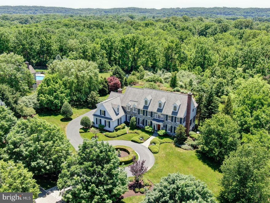 This impressive custom-built home by B J  Drueding Builders located in the highly desirable Community of  Minden overlooking the beautiful George Lorimer Preserve , one of Chester Counties beautiful open spaces with lush flora and meadows and a meandering network of paths and trails. This elegant home with beautiful stone and all new James Hardie Board siding sits on the most prime totally private 1.1 acre lot  on a cul-de- sac filled with relaxing and exceptional peaceful views  of the magnificent landscaped rear grounds with an expansive flagstone patio with lovely wisteria trimmed pergola overlooking an elegant oversized pool with exquisite stone hot tub waterfall cascading into the pool.   The exterior features also include am impressive circular driveway with cobblestone trim with a stately flagstone walkway that steps up to the timeless mahogany front door with transom top and sidelights  surrounded by columns and exterior lighting and a rear driveway leading to an oversized attached 3-car garage. Interior features include beautiful on-site finished oak hardwood flooring on the first  and upper level, extensive custom millwork throughout, two gas fireplaces, transom entryways, wired built-in speaker system, an elegant front to back Center Hall with turned staircase,  formal living room and dining room, a private cherry library/office, gourmet custom kitchen with Paradise custom cabinetry and a large granite island with lovely breakfast area opening to a lovely fireside family room with custom millwork and large feature window overlooking the rear grounds.  Backstairs, an exceptional custom built in pantry room, convenient built in desk area and two  powder rooms complete this level.   The second floor  features a sophisticated master suite with sitting room and  and access to  another bedroom which was converted by the current owner into a lavish dressing room with custom built ins,  glass display cabinetry and large center bureau connecting to a second full  bath to service the master suite, the master bedroom connects to  the original  lavish marble master bathroom and two walk-in closets.  Bedroom 3 and 4 have a jack and jill bath and there is private fifth bedroom suite with a private bath and its own builtin  bar area.   There is also a large convenient upstairs laundry  room and stairs to the floored third floor attic with three dormer windows with room to expand.  An  unmatched finished lower level offers a large recreation room with billard area and a wall of windows, a separate home theater room, an exercise room, and a half bath and a large storage room. . This home offers 6987  square feet of elegant living space on three floors and has additional room to grow. . This home is centrally located just minutes from the towns of Paoli, Berwyn, Devon and Wayne for local shopping and dining and is convenient to all major highways making for an easy commute to center city, the 202 and  422 Corporate Corridor, the  airport and the train.