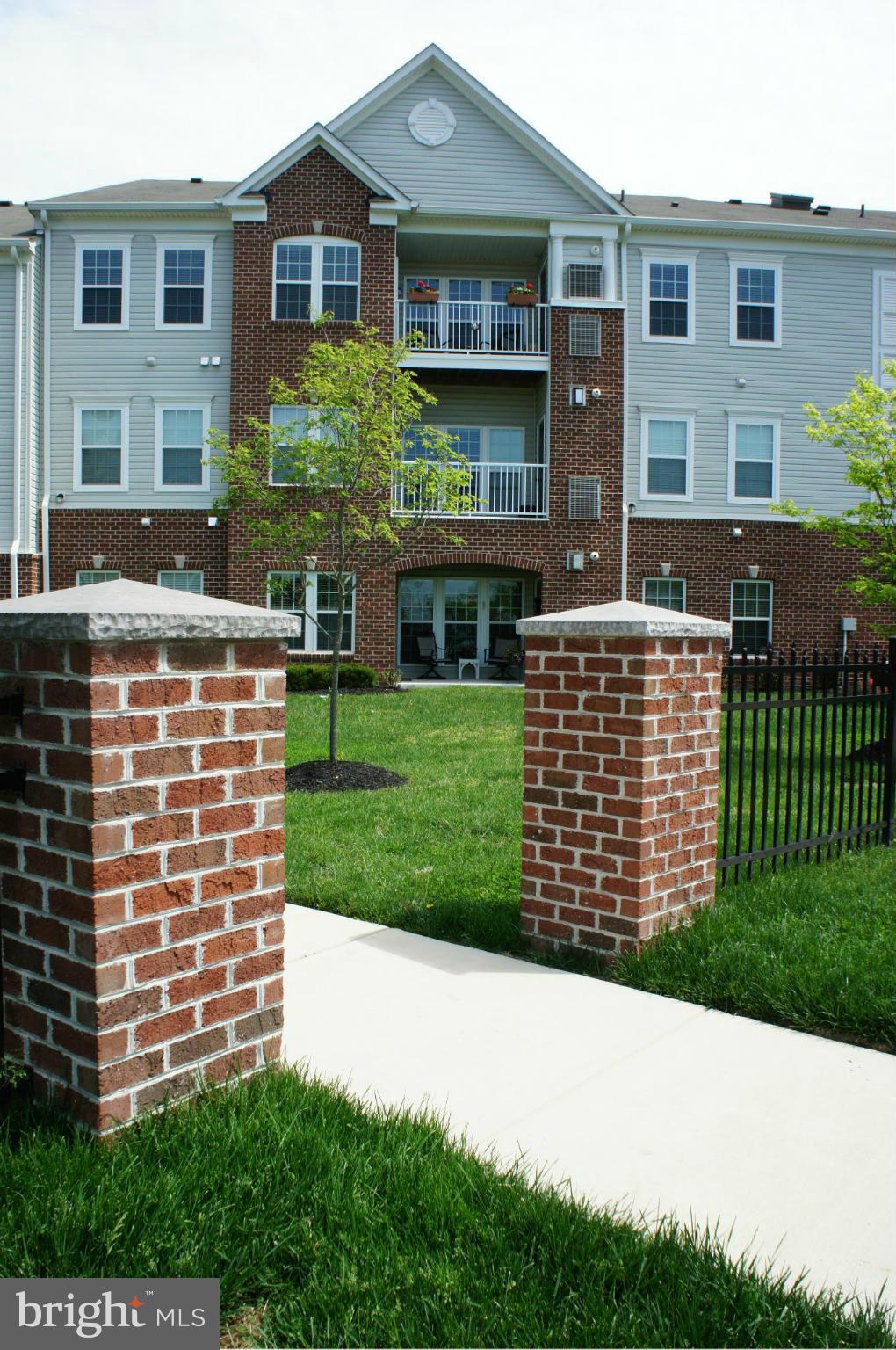 55+ Community, 2 Master Bdrm Condo, Elevator, 2nd Fl Level w/ ground level in rear, Parking Front or Rear of Bldg, Spacious Dining Rm, Living Rm w/ Fireplace, Sunroom off Kitchen, Breakfast Bar, Kitchen w/ SS Appliances, Corian Counters, MBA Shower Seat and Tile, Rear Walk-out Covered Patio & Utility Closet, Harwood & Tile Flooring, Convenient Location, Shows like a Model.