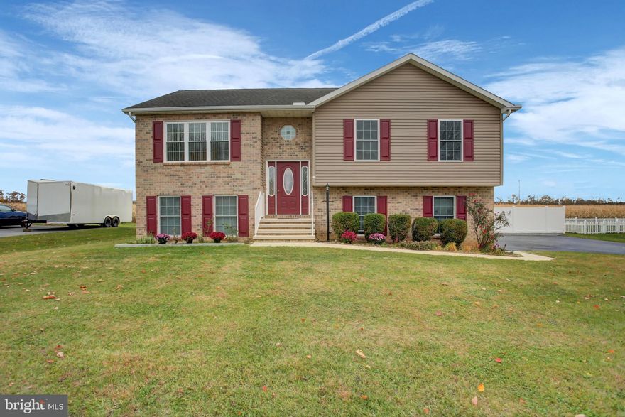 Exceptionally maintained by its original owners, this beautiful 4-bedroom, 2.5-bath modified split-foyer home offers space, privacy, and freedom—no HOA or deed restrictions—and shows like a new home! A rare two-story bump-out on the back left expands the home to a generous 2,150 square feet, creating a layout that lives large and functions beautifully. Additionally, the unique brick-front exterior on the left is a flat - no traditional overhang from the upper level, allowing more square footage for the ground level fourth bedroom. 
Step into a spacious, welcoming foyer that sets the tone for the care and quality throughout. The upper level flows beautifully with a bright living room featuring a brand-new 3-panel window that floods the space with natural light, an open dining and kitchen area that flows effortlessly into a bright sunroom, perfect for morning coffee or entertaining year-round. The primary suite is a true retreat with a walk-in closet and a private bath featuring a dual-sink vanity. Three additional bedrooms provide plenty of space for family, guests, or a home office. 
The ground level offers incredible flexibility with a large family room, laundry, an additional bedroom, and a half bath—all enhanced with new vinyl plank flooring, making it ideal for guests, multi-generational living, or a home office setup. 
Outside, enjoy both a deck and patio, overlooking a large, level, and private backyard—perfect for relaxing, play, or entertaining. The property is further enhanced by white vinyl privacy fencing and two storage sheds, providing ample space for tools, hobbies, or equipment. 
Additional upgrades and features include an oversized two-car garage, updated oven/range with vent hood, garbage disposal, radon mitigation system, a new three-panel living room window, and newer water heater and heat pump with central A/C—offering peace of mind for years to come. 
This is a rare opportunity to own a thoughtfully upgraded, meticulously cared-for home with space, privacy, and no restrictions. Move-in ready and truly exceptional.