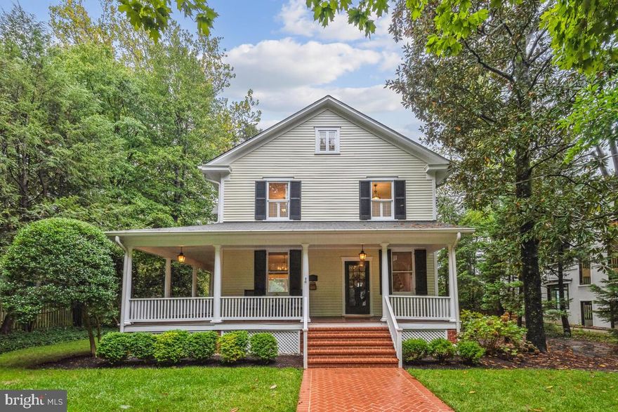 Sited on a tree-lined street on one of the most beautiful and largest lots (over 30,000 sq ft) in the North Chevy Chase community, this classic home presents an opportunity for 21st-century living within the framework of timeless architectural style. A herringbone-brick walkway and wrap-around porch with a beaded ceiling extend a warm welcome into the interior, where 10-foot ceilings and oversized millwork appoint the grand living spaces. The main-level spaces include a formal living room, a spacious dining room with a bay window overlooking the grounds, a powder room and a stunning chef’s kitchen. Honoring the tradition of the home’s original design, the dream kitchen is outfitted with furniture-style cabinetry with beaded glass fronts, windows with intricate iron detailing, a custom hood, crown molding and gorgeous quartz surfaces. The kitchen includes an island, a wine refrigerator, a built-in floor-to-ceiling hutch, and an 8-burner gas stove. So delightful, the adjoining casual dining space opens to and overlooks a deck and a breathtaking, deep level lawn framed by mature landscaping and gorgeous shady trees. The grounds are absolutely beautiful and present every option for expanding the home, if desired.

A wide stairway leads to the upper level, where there are 3 bedrooms and a full, renovated bath. The primary bedroom is next to an original bedroom that has been converted into a custom owner’s closet. Two additional bedrooms are both spacious and light-filled. The bath has been modernized with a separate shower, period-style chandeliers and a tub. Ascend the stairs to the attic level, where bench seating and built-ins craft a storybook style children’s room with an adjoining space for play. In keeping with the home’s style, a soaking tub sits under the window in the full bath. Finished with durable engineered hardwood flooring, the walk-out lower level offers a recreation room, a workshop, a full bath and a laundry room.

Located on a quiet street that is moments to the North Chevy Chase Swim Club, North Chevy Chase Elementary School and the new Chevy Chase Lake retail development, this home has easy access to Kensington’s shopping and dining, walking trails into Rock Creek Park, Bethesda and commuting corridors that ring the nation’s capital. For the buyer seeking authentic craftsmanship with abundant state-of-the-art amenities with the option to further add their own custom design imprint, this is an unparalleled opportunity!