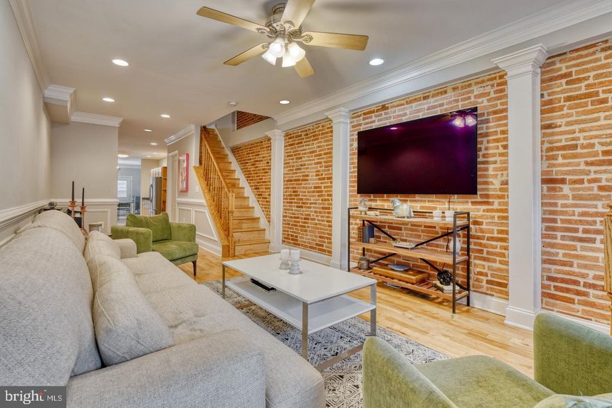 Welcome to a meticulously maintained gem in Federal Hill! This captivating residence spans four well-appointed levels, offering the epitome of city living with the luxury of private parking and a stunning rooftop deck. As you step inside, you'll be greeted by a spacious and inviting open concept on the first floor. Gleaming wood floors, recessed lighting, and exposed brick add a touch of charm to the space. Enjoy the distinction of separate living and dining areas, complemented by a convenient powder room. The expansive kitchen features stainless steel appliances, granite countertops, and an abundance of cabinet space. Adjacent is a delightful breakfast room that opens up to a rear parking pad, providing ultimate convenience. The second level comprises two generously-sized bedrooms, both featuring ample closet space, accompanied by two full bathrooms and a dedicated laundry room. Ascend to the third level, where a wet bar awaits, providing the ideal setting for entertaining guests before stepping out to the enchanting rooftop deck. The lower level offers versatility with options for a third bedroom, a home office, or a family room, complete with its own full bathroom. Located in one of Baltimore's most sought-after neighborhoods, you'll enjoy easy access to the downtown business district, Inner Harbor, restaurants, shops, and entertainment options that define Federal Hill living.