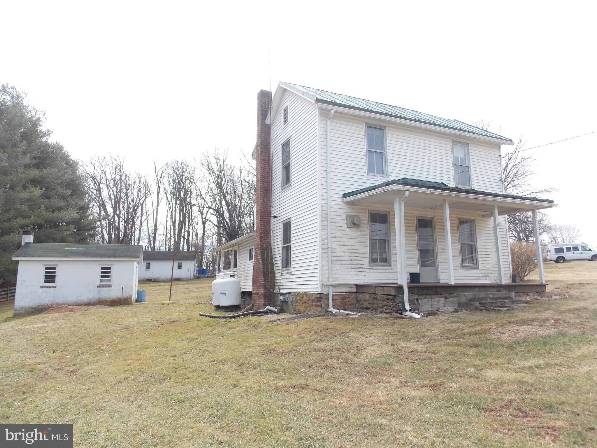 Beautiful Setting in Perfect Location.... Rustic Charm with Lots of space on almost an acre with many outbuildings and a tree lined driveway. 4 Bedroom 2 Bath...Front and Back Porch. Cement basement floor with sump pump. cable ready.. new well pump... 1 car detached garage with office/shop. This is an estate sale and it perfect for a rehab loan but seller will consider with a reasonable offer to make the necessary repairs so buyer can obtain loan.