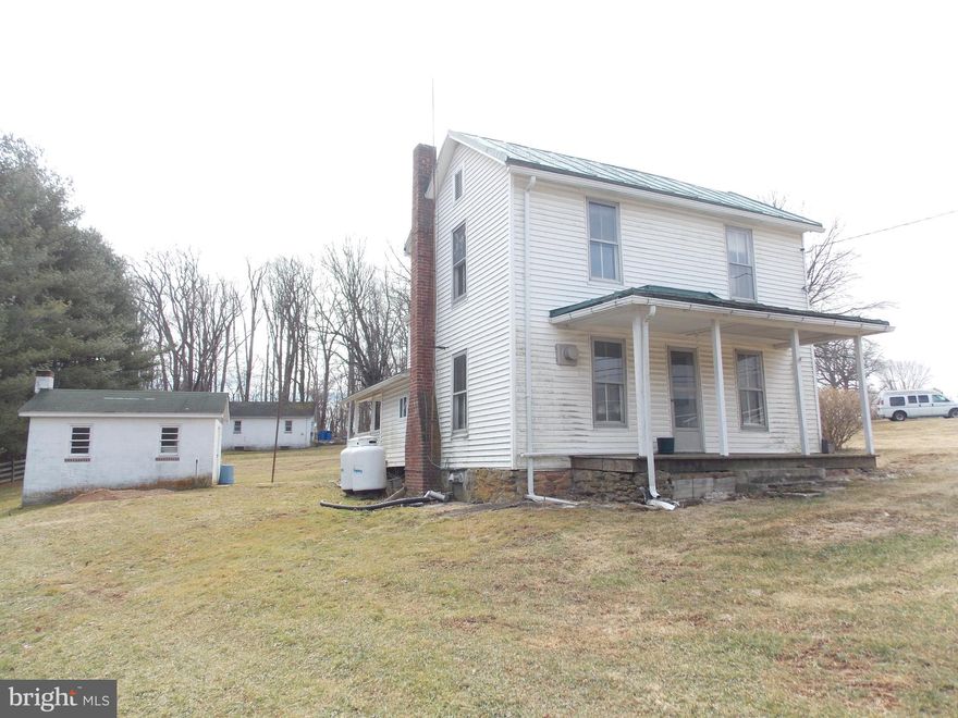 Beautiful Setting in Perfect Location.... Rustic Charm with Lots of space on almost an acre with many outbuildings and a tree lined driveway.  4 Bedroom 2 Bath...Front and Back Porch. Cement basement floor with sump pump. cable ready.. new well pump...  1 car detached garage with office/shop.   This is an estate sale and it perfect for a rehab loan but seller will consider with a reasonable offer to make the necessary repairs so buyer can obtain loan.