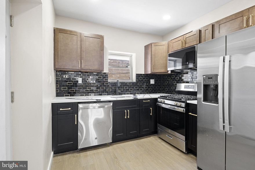 Welcome to 2437 S Beulah St, a recently renovated South Philadelphia home that is fully move-in ready and thoughtfully updated throughout. The open first floor offers a bright and modern layout with a stylish kitchen, powder room, and exposed brick accent wall that gives the home added character. Upstairs features 3 comfortable bedrooms and a spacious full bathroom, while the finished basement adds extra flexibility with a second full bathroom and laundry area. A front porch and small rear patio provide just enough outdoor space to enjoy without heavy maintenance. Conveniently located near shopping, public transportation, local stores, and major highways, this home is a great fit for a buyer looking for updated city living in a walkable location.