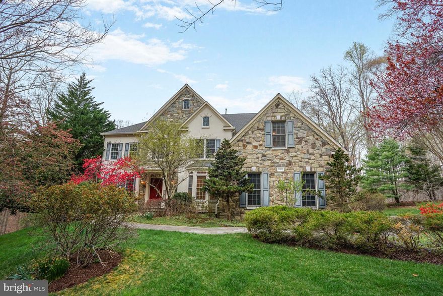 Rare opportunity to own a premier estate in the highly sought-after Estates at Roseland community, available for the first time from its original owners. This exquisite residence features 5 spacious bedrooms, 4 full bathrooms, 2 half bathrooms, and a 3-car side-load garage. Upon entering the grand two-story foyer, you are welcomed into a home that seamlessly combines elegance with comfort. The expansive two-story Great Room, bathed in natural light, opens to a sunroom, creating a perfect space for relaxation and entertaining. A charming solarium, ideal for a baby grand piano, graces the side of the home, adding a touch of sophistication.

The gourmet kitchen is a chef's dream, offering ample space for culinary creativity, while the main-level office, complete with built-in bookshelves and a picturesque bay window, provides an inspiring setting for productivity. The luxurious primary suite serves as a personal retreat, featuring a large walk-in closet and a beautifully appointed en-suite bathroom. Rich hardwood floors flow effortlessly throughout, leading to a spacious private deck where you can enjoy breathtaking, serene views of the lush surroundings.

The fully finished walk-out basement is an entertainer’s paradise, offering a wet bar, recreation room, one bedroom, two additional rooms, and a full bathroom—perfect for guests or hosting gatherings. Set on a professionally landscaped, 8.25-acre lot, this property ensures tranquility and privacy, while still offering convenient access to Route 123, I-95, Fairfax County Parkway, and an array of local amenities, including the Springfield Metro and Virginia Rail Express.