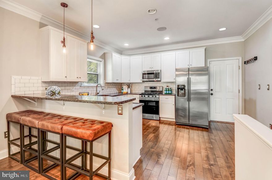 Welcome to Patterson Park! Step into 3039 E Baltimore St — a show-stopping 5-bed, 3-bath end-of-group townhome with over 2,500 sq. ft. of open-concept living! Natural light pours through every window, highlighting the gorgeous hardwood floors and spacious kitchen with a breakfast bar, modern appliances, and plenty of countertop space. Entertain like never before on your private rooftop deck with panoramic city views — perfect for sunsets, gatherings, or relaxing under the stars. Enjoy the ease of an attached garage, a finished lower level for guests or a home gym, and an unbeatable location just steps from iconic Patterson Park, vibrant nightlife, and top-rated dining. Minutes to Johns Hopkins and Bayview Hospitals, this home has the space, style, and energy you’ve been waiting for!