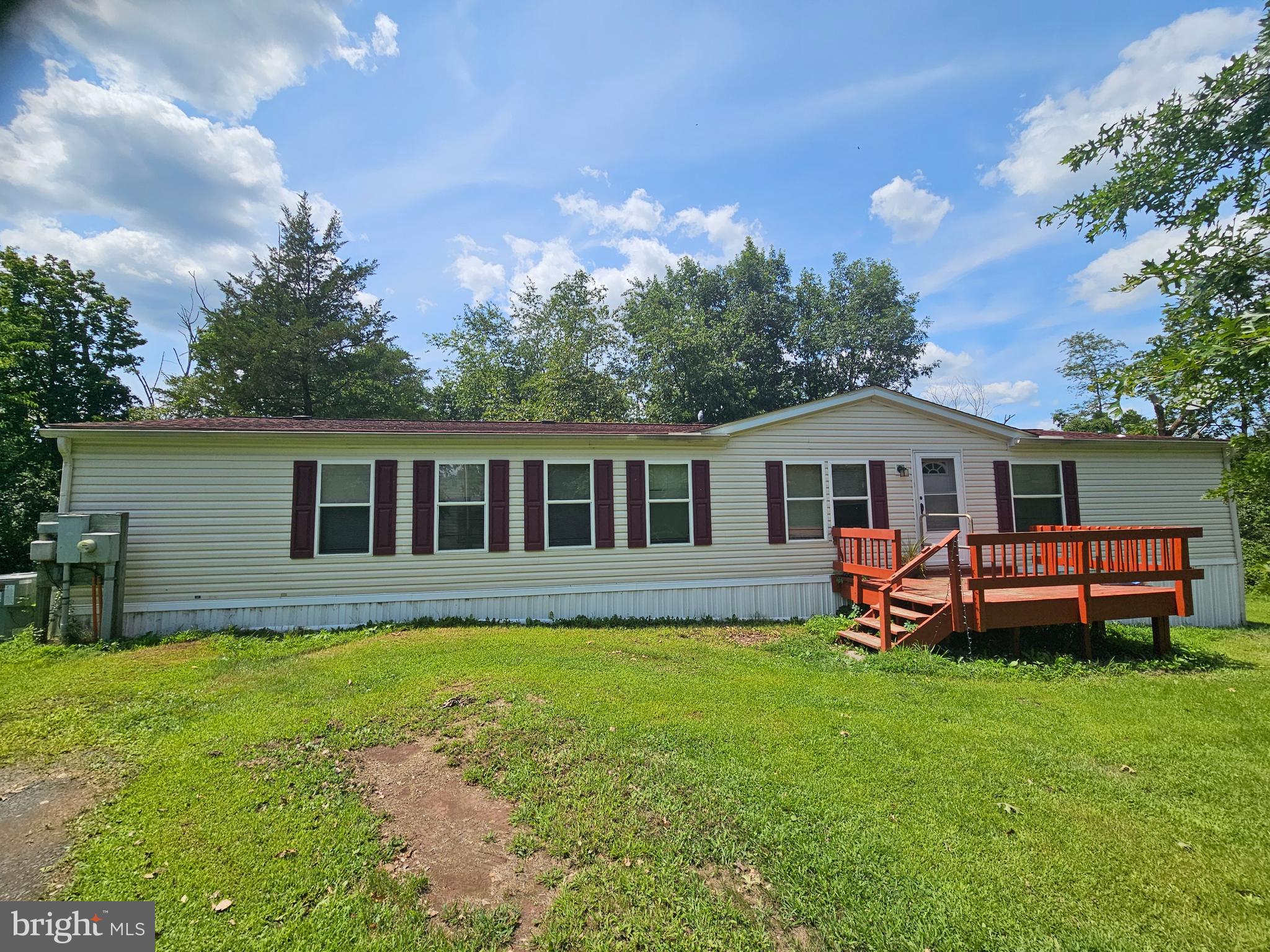 Looking for an affordable place to call your own? This spacious double-wide modular home in Birdsboro might be just what you need! Tucked away on its own wooded lot, this home has tons of room — a big living room with a cozy fireplace, a large eat-in kitchen, and a main bedroom with TWO full bathrooms and TWO closets. There are also two more bedrooms and a full hall bath, plus laundry on the main floor for added convenience. It does need TLC, but the potential is there. Since the home isn’t on a permanent foundation, it’ll require cash or mobile home financing. Have questions? Listing agent can help explain your options! Price includes the house and the land!
