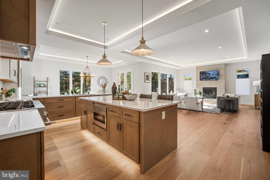 OPEN HOUSE JANUARY 18, 2026  SUNDAY 2 PM to 4 PM.  New Construction! Welcome to this stunning home with 6 Bedrooms, 6 Bathrooms and 2 Half Baths in the prestigious McLean Hamlet! Ready to move in! Exquisite open concept living redefined in this sleek and sophisticated modern design by Bella Home Construction boasting  over 7300 square feet of three finished levels on a beautifully landscaped 0.37-acre lot. Enjoy unmatched convenience of walking down to Spring Hill Elementary school and a quick access to the Silver Line Metro and bus routes.

This home is beautifully designed for both everyday living and grand entertaining.  From the moment you arrive, a charming front porch welcomes you into a dramatic, light-filled open layout featuring 7.5” wide European oak floors, 6" Baseboard, 10 ft ceilings on the main level, 9 ft upper level and lower level. Rich wood accent walls add warmth and texture throughout. 

The main level boasts an expansive family room with tray ceilings and LED lighting, gas fireplace and it opens to a gourmet chef’s dream kitchen, complete with a oversized quartz island, luxury top-of-the-line stainless steel Jenn-Air appliances, under cabinet and floor lights, butlers pantry and a walk-in pantry. Entertain in the elegant formal dining room, complemented by a versatile office or guest suite with a full bath. The bright breakfast area flows effortlessly into the family room and out to the deck, creating the perfect setting for indoor-outdoor gatherings. A stylish mudroom and a doggie spa bath center—accessible from both the kitchen and the garage—enhance the home’s thoughtful design.

On the upper level retreat, the lavish primary suite is a true sanctuary with heated floor in the spa bath, a spectacular 2-person rain shower, a free standing oversized 72” soaking tub , double vanities, a dedicated makeup area and 2 oversized custom walk-in closet. Three additional bedrooms, each featuring a private en-suite bath and generous closet space, provide the perfect blend of comfort and sophistication.  A spacious, dedicated upper-level laundry room is equipped with a front-loading washer and steam-sanitize dryer.

The lower level utilizes the open floor plan to maximize living space and functionality, with a bedroom suite, large recreation room, wet bar and wine cooler, theater, studio/gym and additional half bath. The gas fireplace is an extra added bonus for those cold winter months. 2 car garage and a 240V electric vehicle charging outlet. . Home is located minutes away Tysons Corner Center, Tysons Galleria, Capital One Hall, Wolf Trap, Great Falls National Park, and many more. Located inside the beltway with access to I-495, Route 7, Route 123 and Dulles Toll Road.