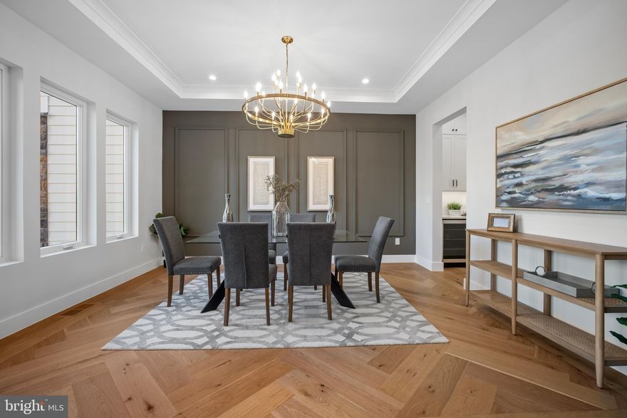 OPEN HOUSE DECEMBER 21,  SUNDAY 2 PM to 4 PM. Home for the holidays! Welcome to this stunning home with 6 Bedrooms, 6 Bathrooms and 2 Half Baths in the prestigious McLean Hamlet! Exquisite open concept living redefined in this sleek and sophisticated modern design by Bella Home Construction boasting  over 7300 square feet of three finished levels on a beautifully landscaped 0.37-acre lot. Enjoy unmatched convenience of walking just a few doors down to Spring Hill Elementary school and a quick access to the Silver Line Metro and bus routes.

This home is beautifully designed for both everyday living and grand entertaining.  From the moment you arrive, a charming front porch welcomes you into a dramatic, light-filled open layout featuring 7.5” wide European oak floors, 6" Baseboard, 10 ft ceilings on the main level, 9 ft upper level and lower level. Rich wood accent walls add warmth and texture throughout. 

The main level boasts an expansive family room with tray ceilings and LED lighting, gas fireplace and it opens to a gourmet chef’s dream kitchen, complete with a oversized quartz island, luxury top-of-the-line stainless steel Jenn-Air appliances, under cabinet and floor lights, butlers pantry and a walk-in pantry. Entertain in the elegant formal dining room, complemented by a versatile office or guest suite with a full bath. The bright breakfast area flows effortlessly into the family room and out to the deck, creating the perfect setting for indoor-outdoor gatherings. A stylish mudroom and a doggie spa bath center—accessible from both the kitchen and the garage—enhance the home’s thoughtful design.

On the upper level retreat, the lavish primary suite is a true sanctuary with heated floor in the spa bath, a spectacular 2-person rain shower, a free standing oversized 72” soaking tub , double vanities, a dedicated makeup area and 2 oversized custom walk-in closet. Three additional bedrooms, each featuring a private en-suite bath and generous closet space, provide the perfect blend of comfort and sophistication.  A spacious, dedicated upper-level laundry room is equipped with a front-loading washer and steam-sanitize dryer.

The lower level utilizes the open floor plan to maximize living space and functionality, with a bedroom suite, large recreation room, wet bar and wine cooler, theater, studio/gym and additional half bath. The gas fireplace is an extra added bonus for those cold winter months. 2 car garage and a 240V electric vehicle charging outlet. . Home is located minutes away Tysons Corner Center, Tysons Galleria, Capital One Hall, Wolf Trap, Great Falls National Park, and many more. Located inside the beltway with access to I-495, Route 7, Route 123 and Dulles Toll Road.