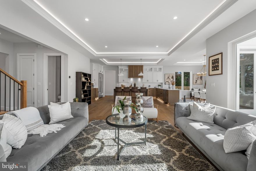 OPEN HOUSE DECEMBER 14,  SUNDAY 2 PM to 4 PM. Home for the holidays! Welcome to this stunning home with 6 Bedrooms, 6 Bathrooms and 2 Half Baths in the prestigious McLean Hamlet! Exquisite open concept living redefined in this sleek and sophisticated modern design by Bella Home Construction boasting  over 7300 square feet of three finished levels on a beautifully landscaped 0.37-acre lot. Enjoy unmatched convenience of walking just a few doors down to Spring Hill Elementary school and a quick access to the Silver Line Metro and bus routes.

This home is beautifully designed for both everyday living and grand entertaining.  From the moment you arrive, a charming front porch welcomes you into a dramatic, light-filled open layout featuring 7.5” wide European oak floors, 6" Baseboard, 10 ft ceilings on the main level, 9 ft upper level and lower level. Rich wood accent walls add warmth and texture throughout. 

The main level boasts an expansive family room with tray ceilings and LED lighting, gas fireplace and it opens to a gourmet chef’s dream kitchen, complete with a oversized quartz island, luxury top-of-the-line stainless steel Jenn-Air appliances, under cabinet and floor lights, butlers pantry and a walk-in pantry. Entertain in the elegant formal dining room, complemented by a versatile office or guest suite with a full bath. The bright breakfast area flows effortlessly into the family room and out to the deck, creating the perfect setting for indoor-outdoor gatherings. A stylish mudroom and a doggie spa bath center—accessible from both the kitchen and the garage—enhance the home’s thoughtful design.

On the upper level retreat, the lavish primary suite is a true sanctuary with heated floor in the spa bath, a spectacular 2-person rain shower, a free standing oversized 72” soaking tub , double vanities, a dedicated makeup area and 2 oversized custom walk-in closet. Three additional bedrooms, each featuring a private en-suite bath and generous closet space, provide the perfect blend of comfort and sophistication.  A spacious, dedicated upper-level laundry room is equipped with a front-loading washer and steam-sanitize dryer.

The lower level utilizes the open floor plan to maximize living space and functionality, with a bedroom suite, large recreation room, wet bar and wine cooler, theater, studio/gym and additional half bath. The gas fireplace is an extra added bonus for those cold winter months. 2 car garage and a 240V electric vehicle charging outlet. . Home is located minutes away Tysons Corner Center, Tysons Galleria, Capital One Hall, Wolf Trap, Great Falls National Park, and many more. Located inside the beltway with access to I-495, Route 7, Route 123 and Dulles Toll Road.