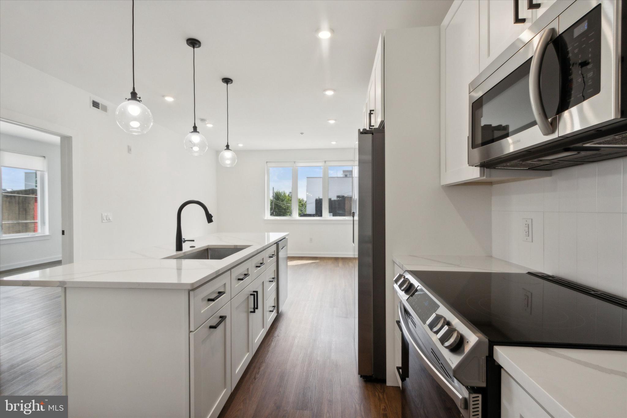 Welcome to The Hudson at 2421 N Mascher St! This expansive 18-unit building offers top-notch convenience and comfort with modern amenities and upgraded features. Dive into the carefully crafted 1 and 2-bedroom apartments featuring hardwood floors, recessed lighting, in-unit laundry, and central A/C + Heat. Enjoy the upscale amenities that enhance your lifestyle, including a state-of-the-art fitness center, secure bike storage, parking for rent and optional additional storage lockers. Enter Unit 204 to a stunning kitchen with upgraded appliances and island seating. The oversized living area is perfect for hosting guests, while the bedroom features a walk-in closet and access to a private bath..