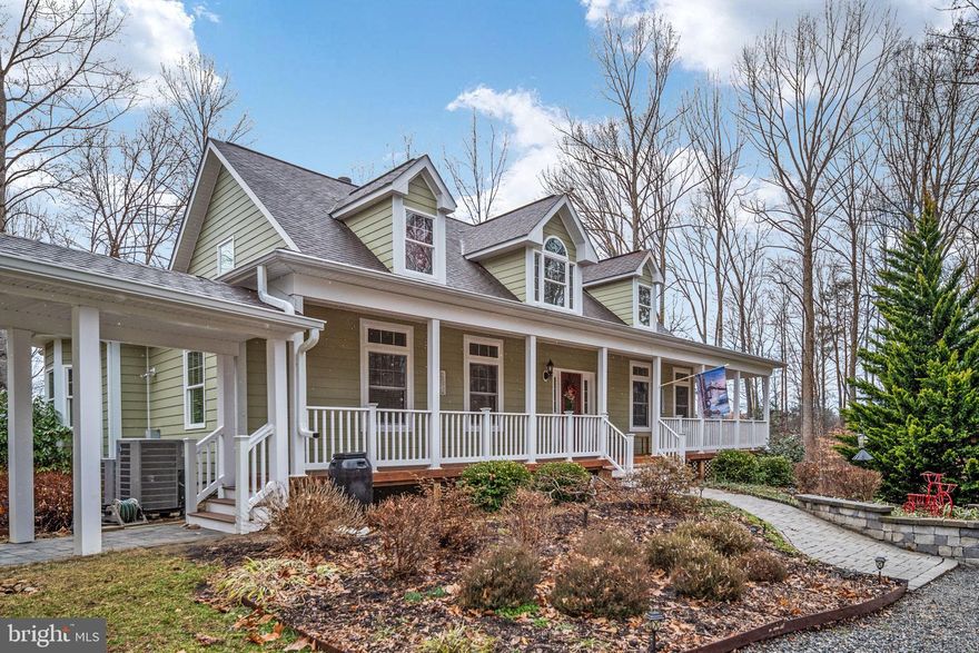 Welcome not 3900 Water Front Court on the Public (cold) Side of Lake anna.  Located in Sycamore Shoals.  A medium density community with large lots and plenty of old growth trees.

Home is located on a cul-de-sac.  Follow the driveway  and around the circular drive to arrive at the house.  Plenty of parking and easy and access to the garage.  A beautiful Cape Cod style house with a covered wrap around porch and a simi detached garage that joins the house by a covered walkway.  This home has wonderful flow from one room to the next for easy movement through the house.  

Home features high ceilings and a wall of windows facing the lake.  A main level primary bedroom with ensuite.  Full bath on each level, 2 of which are on the main level.  2 bedrooms and a bath on the upper level.   Kitchen has a gas stove and a double oven. One gas fireplace, one wood burning fireplace.  Living room, den/guest room, dining room, eat in kitchen, family room with wet bar and a large storage area.  The lower level is walkout to grade.  New carpet on the main level.   2 water heaters and 2 HVAC systems.  The 2nd of each can be turned off at the breaker when demand for low.  
The oversize garage features 2 parking spaces inside and a carport outside.  There is an unfinished space above the garage that is accessed by the stairs inside.
There is an adorable potting shed in the back yard.  Ample room for a mower and planting supplies.  
Down to the water the shoreline has been left natural.  The boat house has 2 slips.  Each has an electric lift.  The boathouse has a locking storage closet, screened porch and a large deck that covered as well as an uncovered portion for soaking up the sun.
The homeowner is an avid gardener, so the yard has been planted with native perennial plants that fill the yard with color all spring and summer long and for each year to come
Don’t miss out on your chance to own this beautiful home.