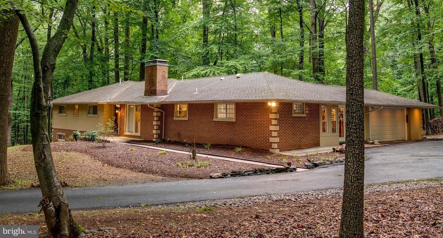 Beautifully appointed contemporary rancher on a large private lot in Velvet Valley awaits you. The front door greets you with custom mosaic floor tile,  leading you to an inviting living room and formal dining room with solid cherry floors, custom chair rail, crown molding, floor to ceiling french doors walking out into a large deck perfect for family gatherings or some quiet time enjoying the nature surroundings. Custom eat-in kitchen has been updated with cherry cabinets, stainless steel appliances and exotic granite countertops, features a wood burning fire place for cozy family breakfasts. On the main level there are three large bedrooms, an office,  a sitting room and a powder room. The master bedroom quarters offer a large room with a walk-in cedar closet, super bath with a separate soaking jacuzzi tub and a large walk-in shower with granite cill, river-stone shower floor and glass shower surround, and a custom vanity. Lower walk-out level is your own blank canvas: open large family room, with a gym room, a guest quarters with the full bathroom, and an office.  1.97 acre lot is ready for your imagination, located in Velvet Valley, one of Baltimore County's best neighborhoods.