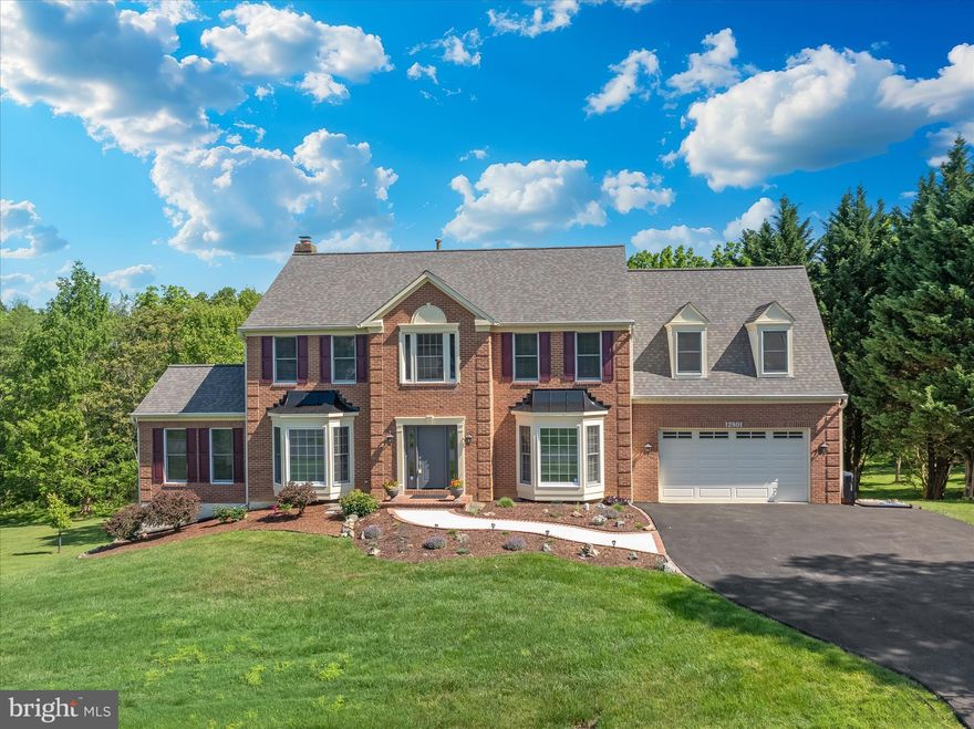 Serenity meets sophistication on this corner lot in Darnestown's Quail Run community. The moment you turn onto Buck Lane, a quiet street of just four homes, you arrive home: 1.84 acres of mature grounds backing to woods, a creek, and Jones Lane Elementary School, with a deck positioned to watch wildlife move through the landscape. A live fence buffers one side and woods anchor the back, delivering true privacy on every angle. This five bedroom, three and a half bath home has been meticulously cared for and demands nothing but your arrival. A new sidewalk and premium ProVia front door set the tone before you even step inside.

The main level showcases multiple living spaces designed for today's lifestyle: a formal dining room, three distinct living areas including a flexible office or creative studio, and a fully renovated kitchen anchored by custom Brighton maple cabinetry, a Broan Elite range hood, Kraus sink, under-cabinet lighting with warm-to-cool settings, premium appliances including a brand new Samsung refrigerator, a four-seat breakfast bar, a dedicated breakfast room, a main level laundry and mud room, and a spacious double cabinet pantry. Over 30 windows and three sets of French doors flood the home with natural light, complemented by a warm earth-tone palette throughout.

Upstairs, the primary suite delivers true spa-level retreat: vaulted ceilings, a freestanding soaking tub, a frameless tempered glass shower with custom niches, one-piece Corian integrated vanity, designer fixtures in Champagne Bronze, and a Schluter waterproof system throughout. A walk-in closet is accessible from both the bedroom and bath. The second-floor full bath has been finished with designer porcelain tile work. Three additional bedrooms, including one substantially larger than the primary with its own closet, complete the upper level.

The finished walkout basement extends your home's functionality with waterproof luxury vinyl plank flooring, two light-filled rooms ideal for a home office setup, a full bathroom with custom tile work, a large finished storage room, and a finished bedroom that adapts as a bedroom or gym.

Every detail has been thoughtfully upgraded. The newly paved driveway, fresh roof, repainted exterior woodwork, and new front sidewalk signal the meticulous attention to quality throughout. Zoned for Jones Lane Elementary School just steps away. This is a home where nothing remains to be done. Move-in ready. Thoroughly refined. Waiting for you.