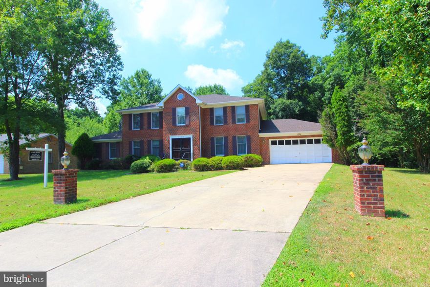 5 bedroom, 3.5 bath All Brick colonial with 2 car garage & over 5000+SQFT. French doors to Deck overlooking .7 acre lot & tons of great updates! New Roof, Granite countertops, New Appliances, New carpeting, fresh paint, and more. Finished Walkout Level basement has soaring high ceilings, beautiful brick fireplace, wet bar, dj booth..Perfect for entertaining!