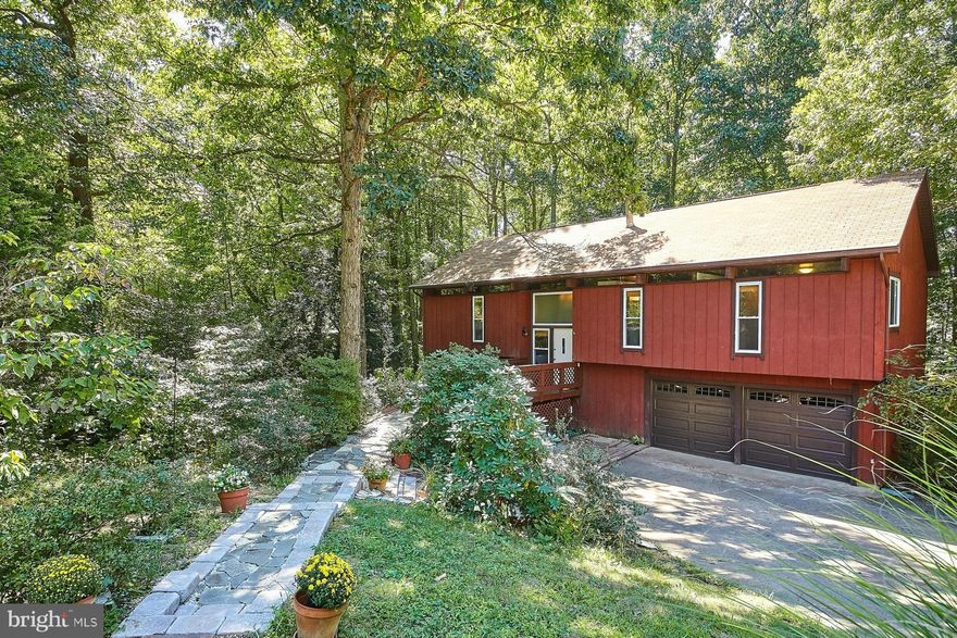 This lovely 4 BR 3 full BATH home w/ over-sized 2 car garage is situated on nearly 1/2 an acre wooded lot. Freshly painted w/ many updates including Kitchen, Bathrooms, Windows, Garage doors & much more. Lower lvl Recreation Room is equipped w/ wood burning fireplace. Enjoy the expansive deck w/ access from the Dining Room, Kitchen & Master Bedroom. Close to shopping & VRE. **Colgan High School**