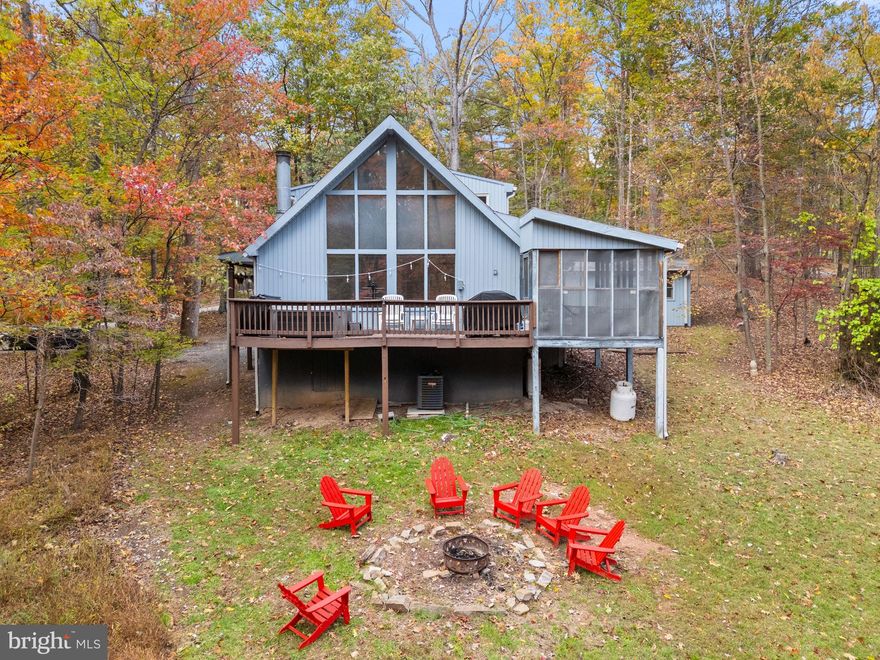 Completely remodeled cabin located in The Woods Resort!  Beautiful wood-burning fireplace, wood floors, stainless steel appliances, screened in porch, large deck with a hot tub, and a huge yard.  Professionally designed with all new furniture and modern decor.  Seller spent over $44,000 upgrading & furnishing the property.  As a vacation rental it has generated $125,000 over the past 2.5 years, and can come with an existing property manager and cleaner. This cabin is located in The Woods Resort, a private community with an 18-hole golf course (with low green fees), spa, a restaurant and pub, and miles of walking/hiking trails. Currently has Class B membership. Hot tub and furniture optional, available for purchase.  See seller docs for a summary of rental history and financials.  $1,000 buyer credit if you continue using the same property manager.  Perfect vacation home or investment property!