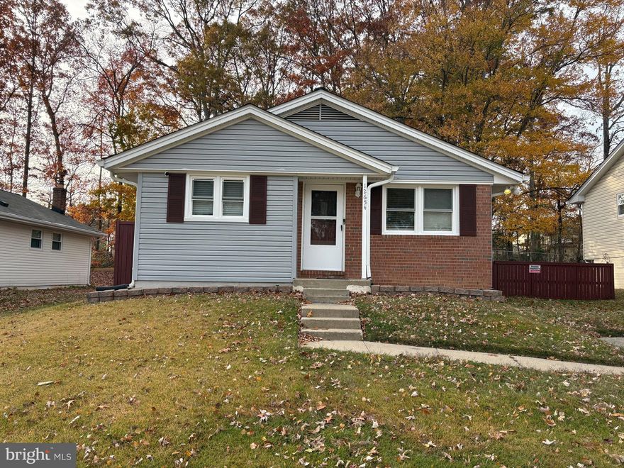 Charming two-level single-family home in the heart of Lake Ridge! The main level features three bedrooms and two full baths, along with separate living and dining rooms and a spacious eat-in kitchen. Step out onto the deck from the kitchen to enjoy a fenced backyard that backs to serene trees, perfect for relaxing or entertaining. The lower level offers a bonus room, an additional spacious room with attached walk in closet, a full bath, laundry room, and a generous storage area. Conveniently located near shopping, schools, and community pools, this home combines comfort and location for the perfect lifestyle.