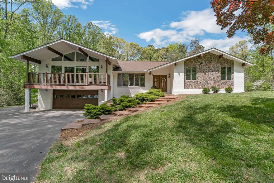 Located on 3 wooded acres just minutes from the water, this stunning 4-bedroom, 3-bathroom home is the perfect blend of privacy, charm, and modern convenience. A recent kitchen renovation serves as the heart of the home, featuring butcher block countertops, custom cabinetry, stainless steel appliances, and a spacious island perfect for entertaining or family gatherings. The custom wall pantry provides ample storage as well as a slide-out shelf which is perfect for your morning coffee or tea.

In addition to the beautifully renovated kitchen, this home boasts a spacious family room designed for both comfort and style. Centered around a gas fireplace, the room invites you to relax and unwind. A wall of windows floods the space with natural light and offers sweeping views of the surrounding woods.

The beamed ceiling adds a touch of rustic elegance, enhancing the room’s warm, welcoming atmosphere. Whether you’re curled up with a book, watching a movie, or gathering with loved ones, this family room is sure to become the heart of the home. It’s the perfect spot for year-round enjoyment — bright and airy in the warmer months, and beautifully cozy when the fire’s glowing in the winter.

Retreat to the spacious primary suite, complete with an en-suite bathroom and generous closet space. Three additional bedrooms provide flexibility for family, guests, or a home office.

Outside, you’ll find space to roam, garden, or simply enjoy nature, all while being a short drive from the water. The new homeowner will have the option to join the local community center which includes a community pool and water access. Whether you're seeking a peaceful retreat or a stylish space to entertain, this home offers the best of both worlds. 

Altogether, this thoughtfully updated home combines modern amenities, timeless character, and a peaceful natural setting to offer an exceptional living experience. With room to grow, entertain, and make memories, it’s truly a one-of-a-kind property just moments from the water.