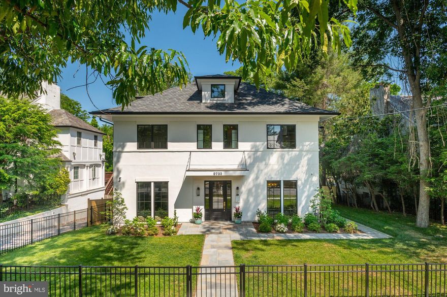 Ideally positioned on a quiet cul-de-sac on one of the most coveted streets in Forest Hills, just moments from the neighborhood favorites along Connecticut Avenue, the Washington Metro Red Line, and the scenic trails of Rock Creek Park, 2733 Chesapeake Street NW is a newly constructed residence that blends timeless architecture with sophisticated modern living. Spanning four beautifully finished levels, the home offers refined design, exceptional scale, seamless indoor-outdoor flow, and elevator access.

Designed with entertaining in mind, the outdoor spaces include a screened porch, private terrace, flat front and rear yards, and a stunning 10-by-20 soaking pool, creating a serene, resort-like setting surrounded by mature greenery and scenic vistas.

Inside, wide-plank hardwood floors, designer lighting, and curated finishes create a warm, elegant atmosphere. The main level is anchored by a spectacular chef’s kitchen featuring an oversized island, custom cabinetry, professional-grade appliances, and a beautifully appointed butler’s pantry. The adjoining family room with fireplace opens seamlessly to the screened porch, extending the living space outdoors.

The upper levels include a luxurious primary suite with treetop views, dual walk-in closets, and a spa-inspired bath, along with three additional en-suite bedrooms. The top floor offers a private lounge, additional bedroom, and full bath, ideal for guests or flexible living space.

The walk-out lower level is designed for recreation and entertaining, highlighted by a dramatic space with soaring 11-foot ceilings ideal for a golf simulator or private theater, along with areas for a gym, lounge, and guest suite.

Thoughtfully built with an emphasis on quality and craftsmanship, this exceptional home offers a turnkey living experience in one of Washington’s most sought-after neighborhoods.