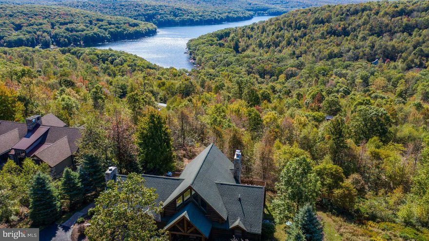 4/5BR + loft, 3.5 BA lake view log home at coveted DC Highlands! Elegant Lodge feel and incredibly well appointed. Features include oversized logs and elegant woodworking details, open floorplan with spacious loft area, three fireplaces, sun room, rec room and spacious bedrooms. Outside, impressive landscaping and hardscaping features with a brick patio and custom fire pit with Lake and Mountain views. Community amenities include outdoor swimming pool, tennis courts, hiking trails & playground.  Must see in person to appreciate! TM rental Water logged, $48k+ in rental income in 2022.