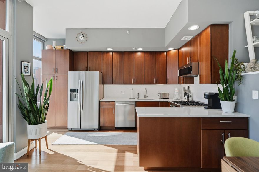 Sophisticated and sunny south facing condo with tranquil garden and courtyard views in one of Old City’s premier boutique doorman buildings. This beautifully updated 2 bedroom, 2 full bathroom home offers modern finishes, excellent natural light, and a seamless indoor outdoor flow with a private terrace overlooking the landscaped courtyard.

The fully renovated kitchen features rich wood cabinetry, high end stainless steel appliances, custom quartz countertops & matching backsplash, and opens to the living and dining area. Heated cherry hardwood floors add warmth and sophistication throughout. The primary suite includes 3 generous closets and a fully renovated ensuite bathroom with heated tile floors, large glass shower, a luxurious Japanese soaking tub, and plenty of storage. Additional highlights include tinted windows, electric blinds, and an in-unit washer and dryer.

Built in the mid 2000s, this 42 unit boutique building offers a beautifully appointed lobby, landscaped courtyard, common roof deck with panoramic skyline and bridge views, and doorman service. Pet friendly and professionally managed. A Gold Star HOA community! Ideal location for access to Old City shops & restaurants, Center City, I-95, Airport, & New Jersey. This home places you steps from the new transformative waterfront park at Penns Landing, an 11.5 acre park connecting Old City to the riverfront. Enjoy refined city living in one of Philadelphia’s most sought after locations!